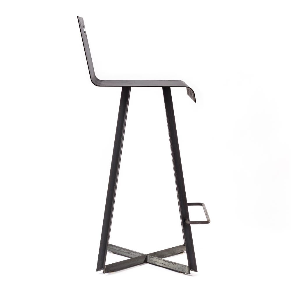 Designed by Basile Built, renowned Design-Fabrication Studio based in San Diego, California, hot rolled steel is shaped into a durable barstool with simple lines and a sturdy presence softened with a key-detail purse hook. Gunmetal-waxed finish will