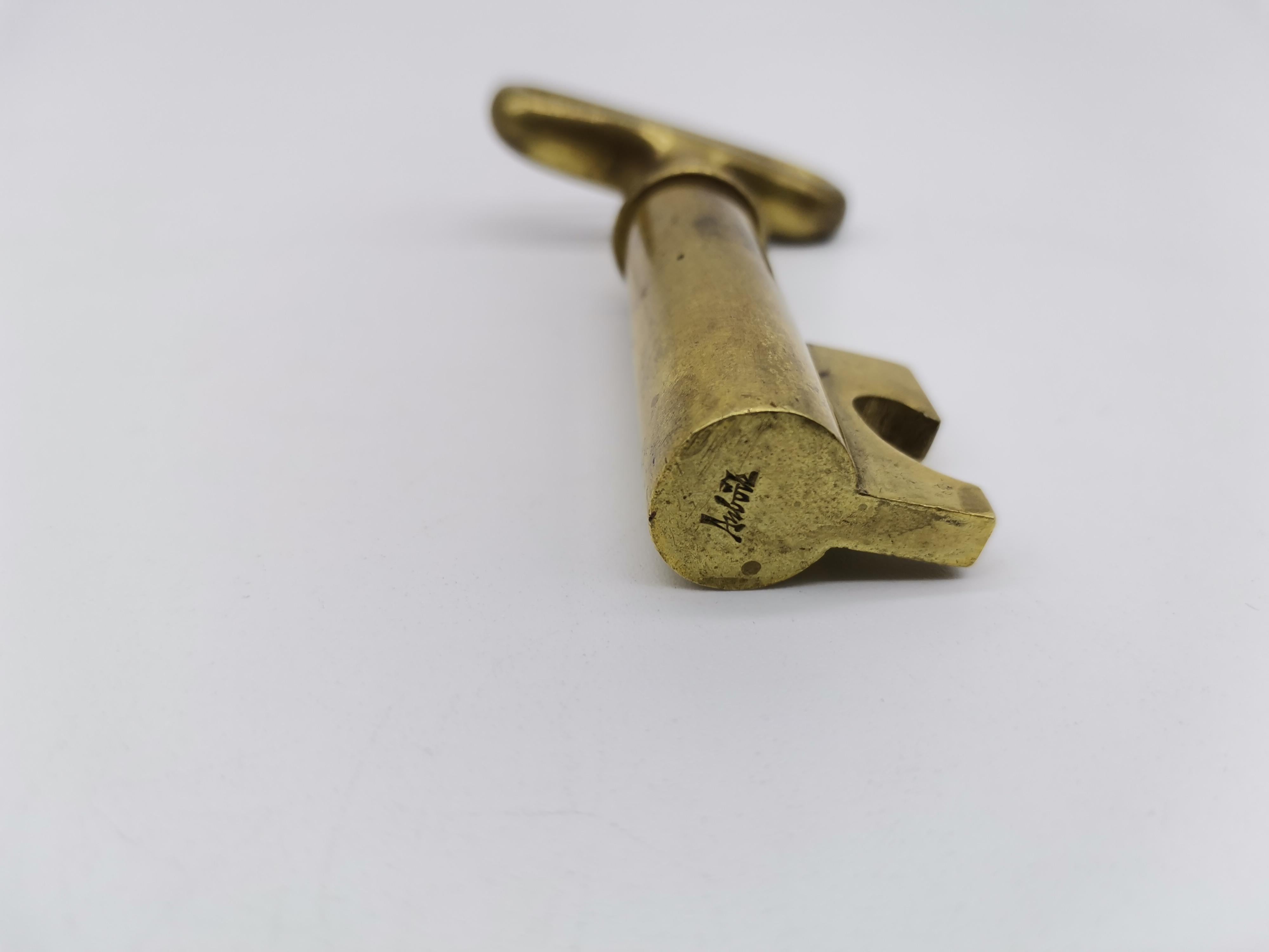 A cork screw made of brass in shape on a key by Carl Auböck.