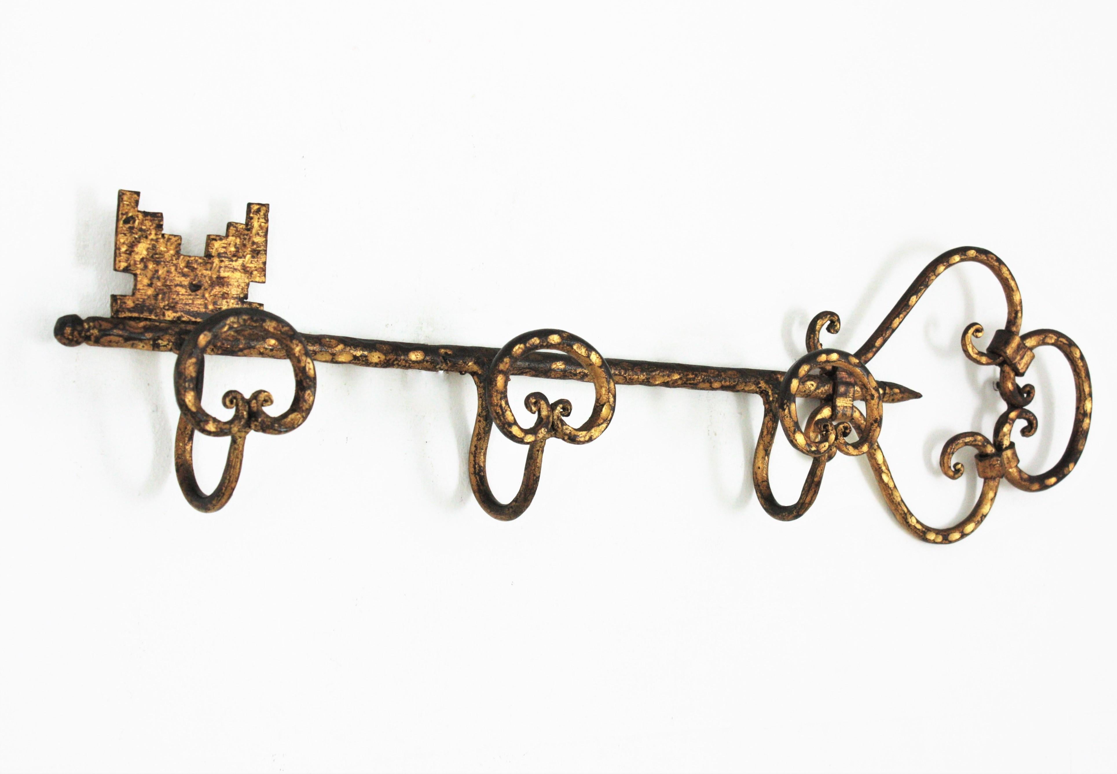 Eye-catching gold gilt hand-forged iron coat / hat rack in the form of a giant key. Spain, 1940s
This large key shaped hat and coat rack has 3 large coat hanging hooks. It has a pretty beautiful gothic style design, all made in wrought iron. It is