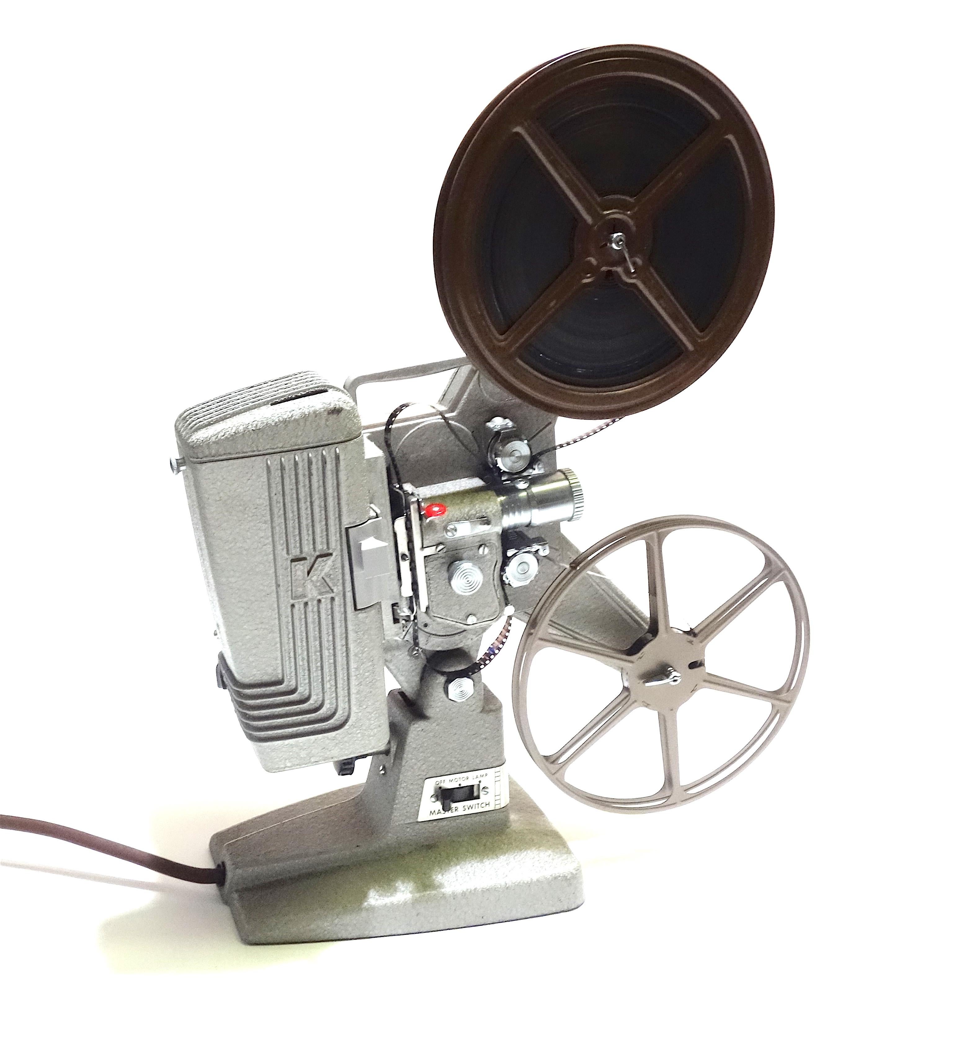 Submitted for your consideration is this circa 1950s Keystone 8mm movie projector in extremely rare pristine condition. 
The cinema projector looks as new and comes complete with a reel of film and a take up reel, power cord, factory lens and