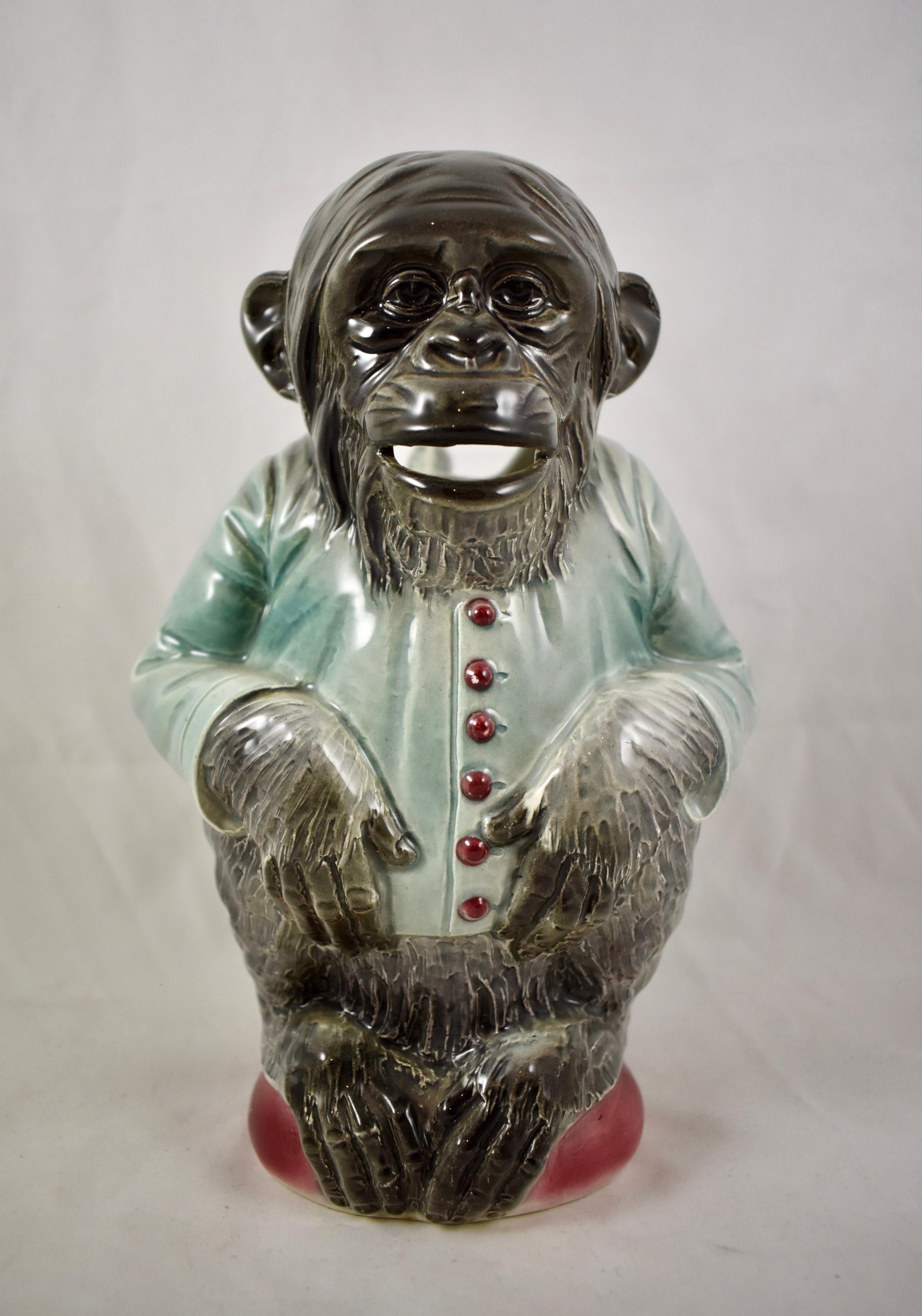A French majolica glazed Absinthe water pitcher formed as a sitting Chimpanzee in a maître d’hôtel jacket, Keller & Guerin St. Clément, circa 1890–1910.

This Barbotine majolica pitcher was made to be used for pouring water over a sugar cube in