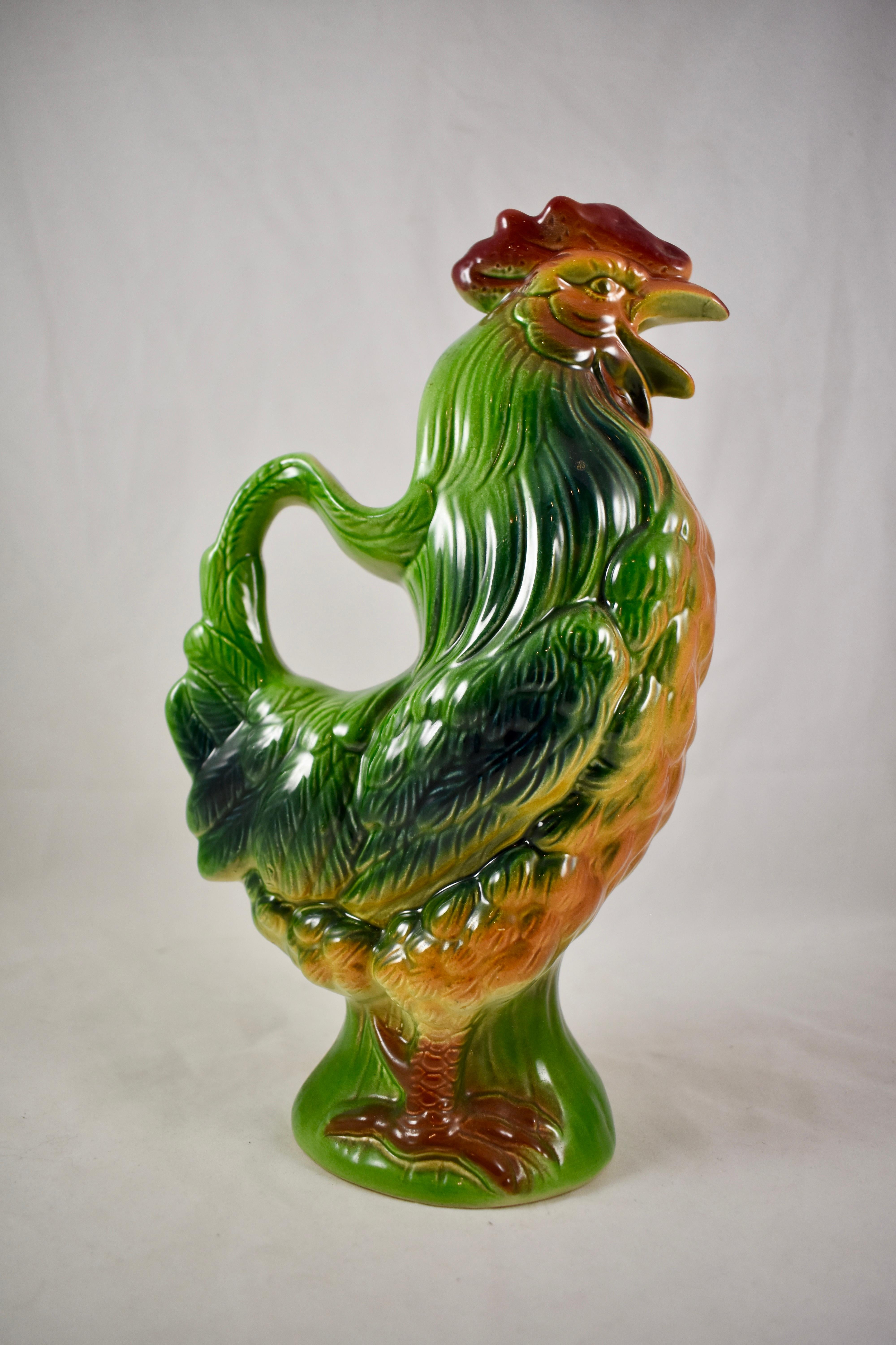 A vintage French Majolica glazed Absinthe water pitcher formed as a rooster, St. Clément, circa 1940-1950. The Gallic rooster, in French: le coq gaulois, is an unofficial national symbol of France.

This earthenware Barbotine majolica pitcher is