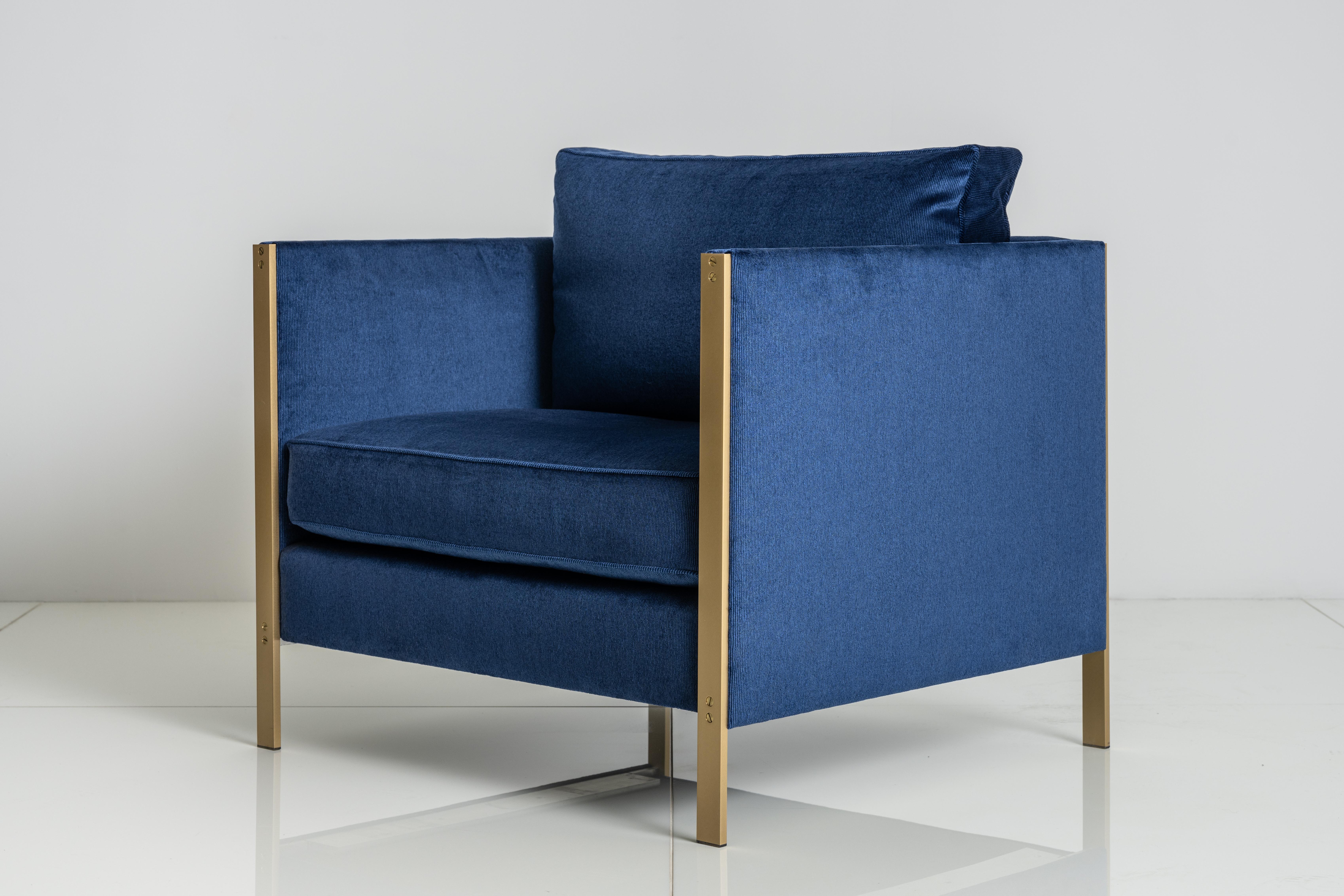 The architectural rigor of the Armstrong Armchair's mechanically fastened, metal frame forms a striking juxtaposition to the generously proportioned, down-filled seat and back cushions.

Shown with a Solid Brass frame and Navy Corduroy.

W 36” x D