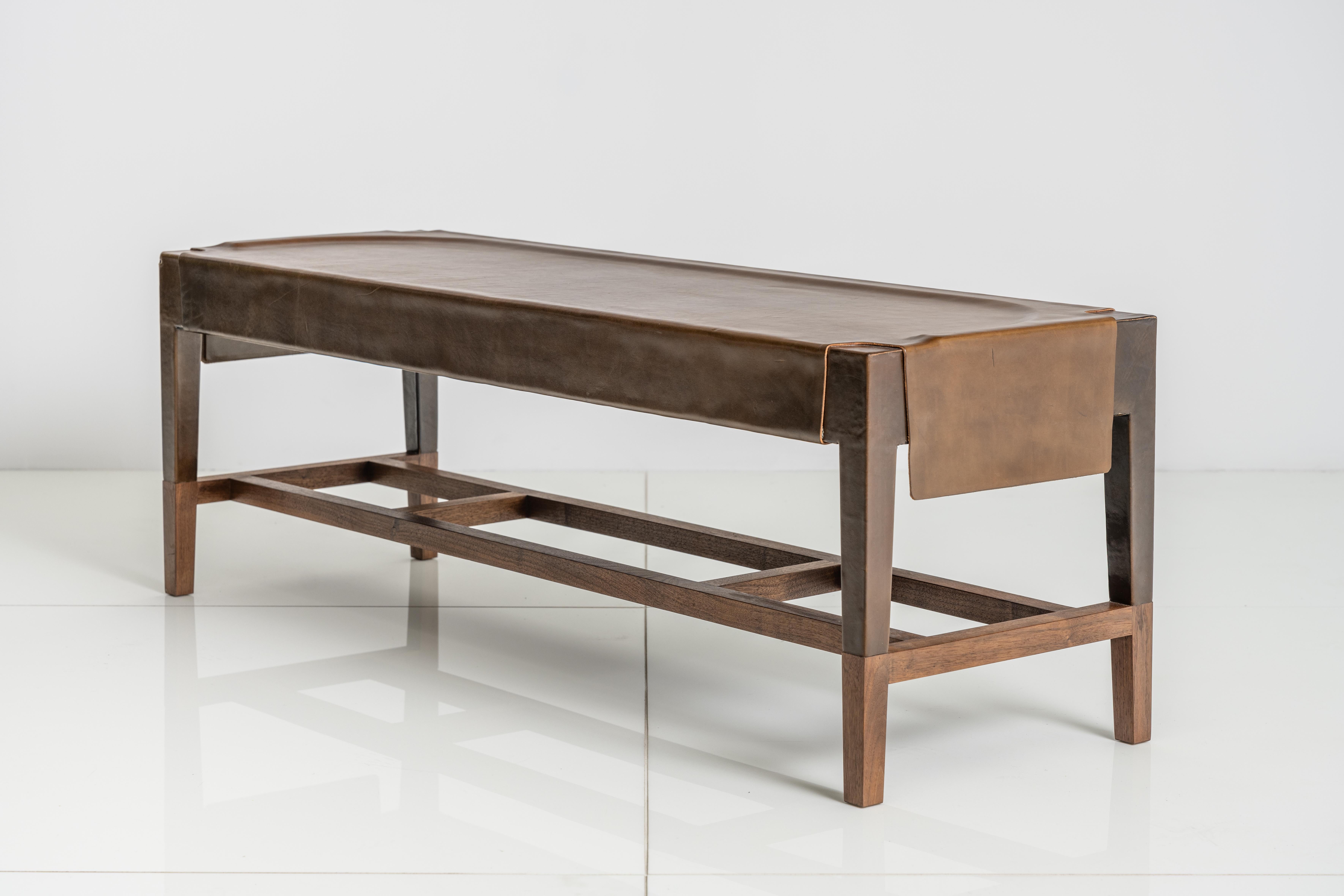 The centuries old process of forming water saturated leather hide over a wood frame forms the essence of the Cassius Bench, which is then exposed at the base to reveal co-planar, walnut legs.

This is a natural product that may have slight