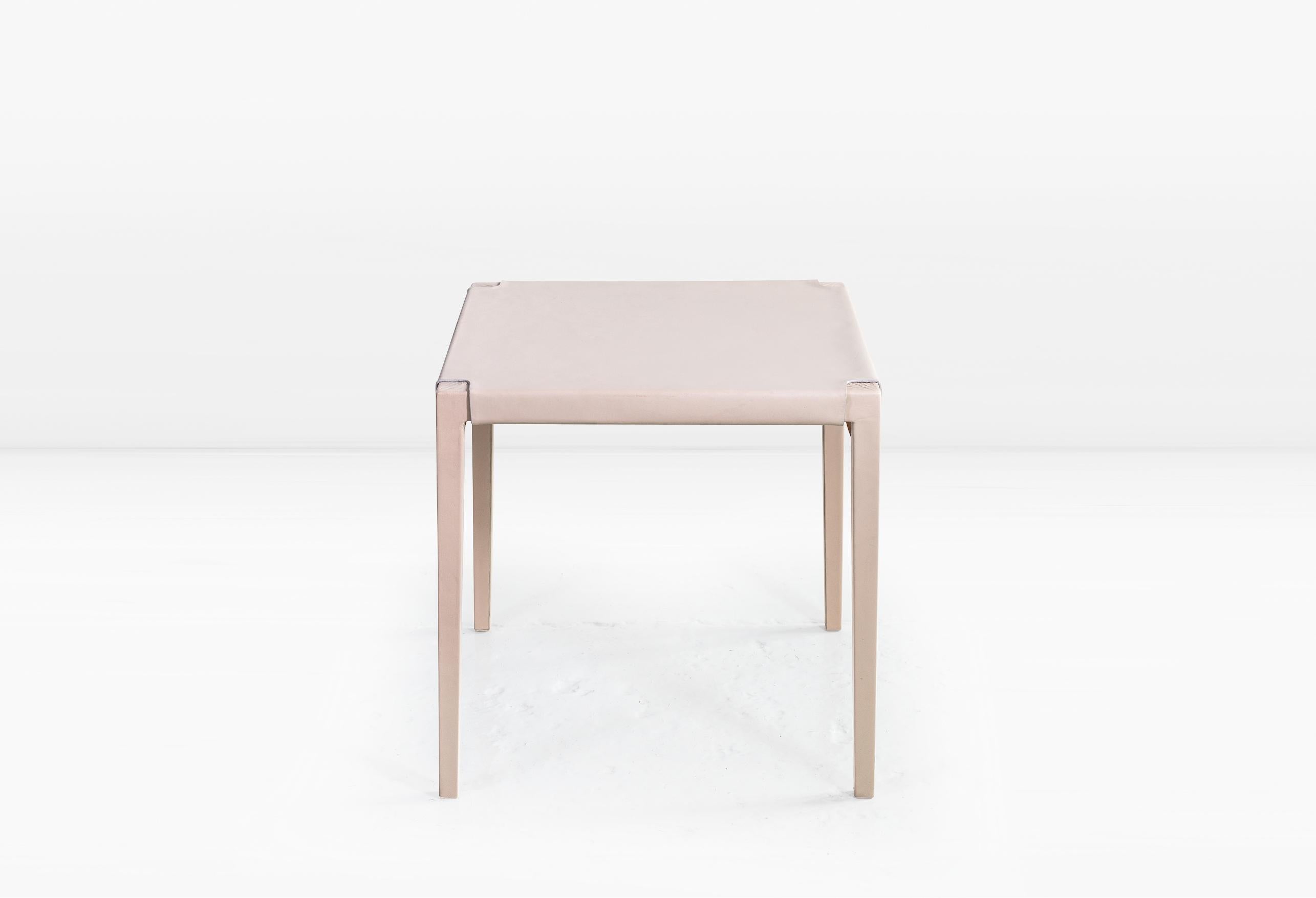 Utilizing a centuries old technique, water-saturated leather hide is molded and stretched over a maple frame to create the Emile Table. Shown in Cream leather.

This is a natural product that may have slight imperfections. This is the beauty of the