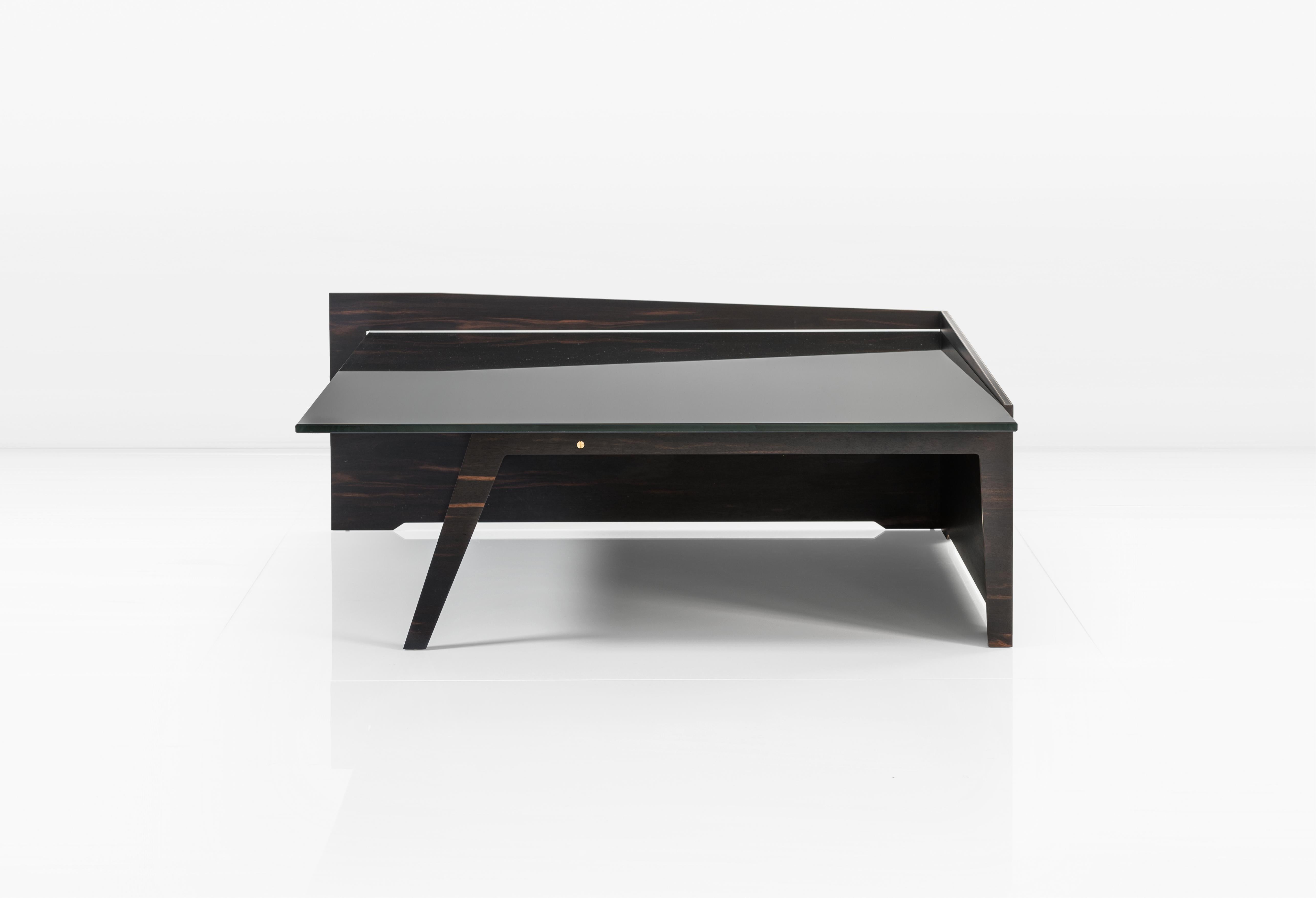 The Keenan Coffee Table features African Ebony that's paired with a bronze interlayer and black glass top. 

This is a natural product that may have slight imperfections. This is the beauty of the product and makes it unique from other items out