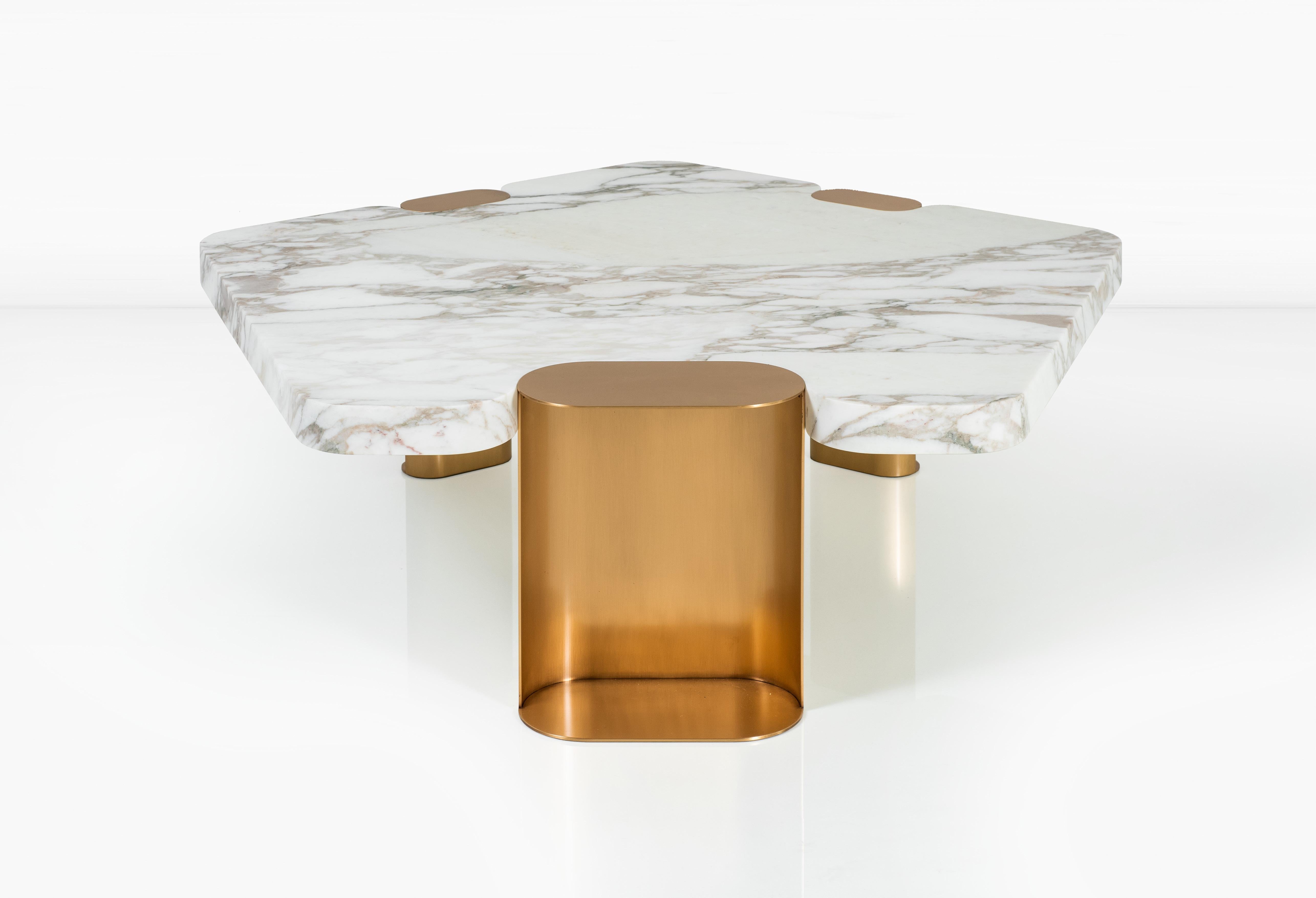 The Laguna Coffee Table is the exploration of a rarely used shape in design: the pentagon. The five-sided form of Calacatta Vagli marble is softened by the addition of lozenge shaped leg assemblies in solid bronze. The Laguna provides an unexpected
