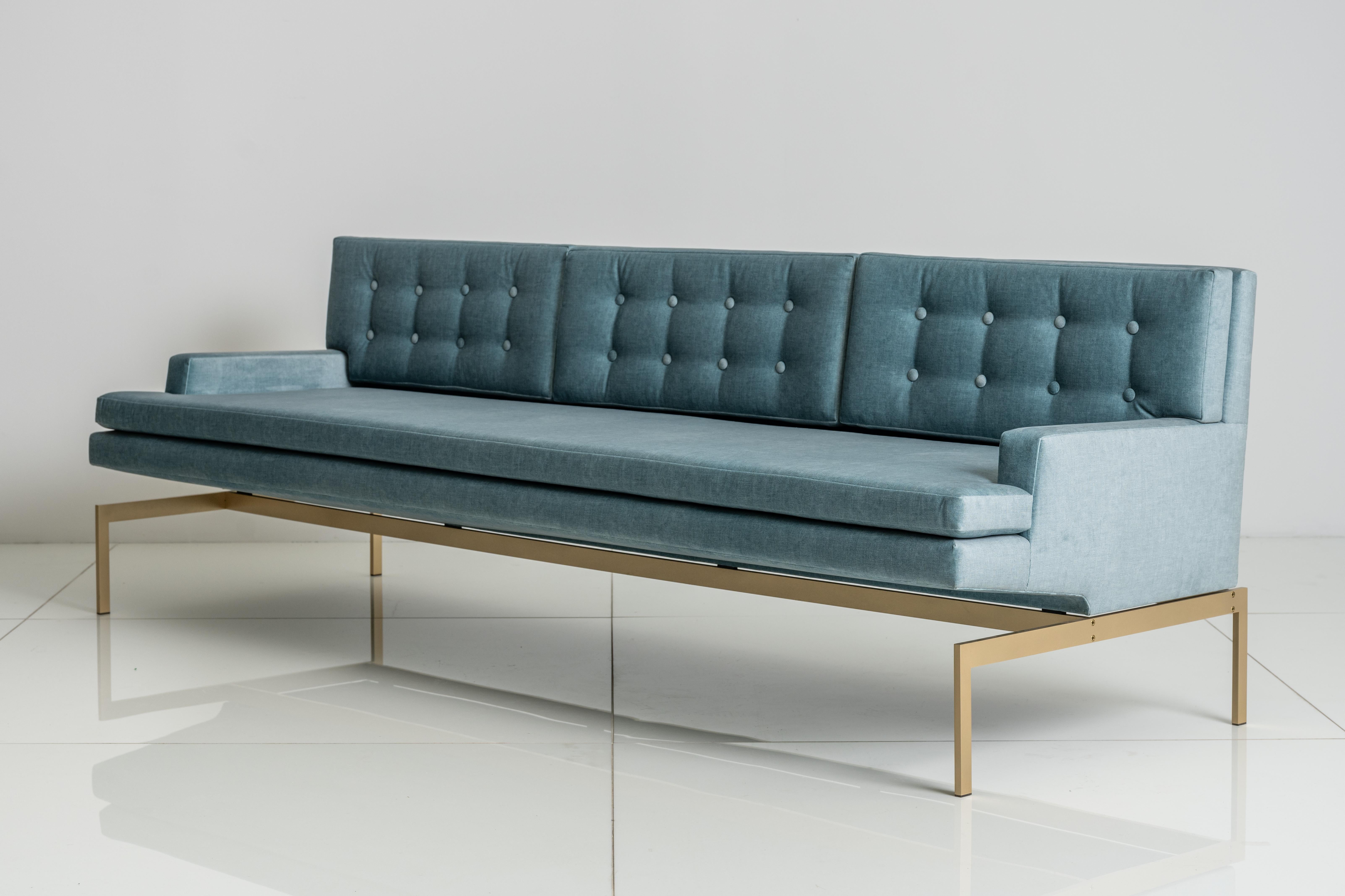 The Mancini Sofa has a seat specially constructed to float above the metal base and give it a singular silhouette. 

Shown with a Silicon Bronze base and Blue Velvet.