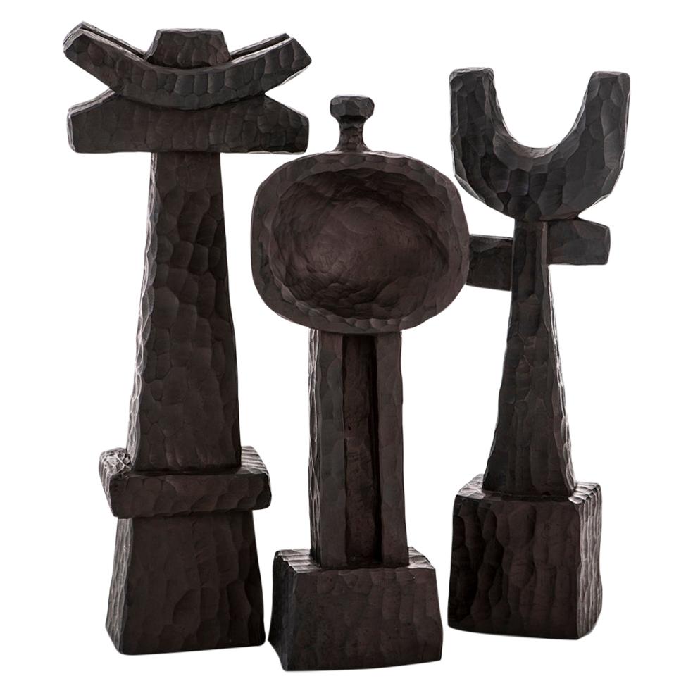 All our totem sculptures are hand carved in Southern Africa from sustainable alien timber by a group of Zimbabwean artists who set their own prices, thus making them fair trade. 

These sculptures have a strong African, primal and Brutalist