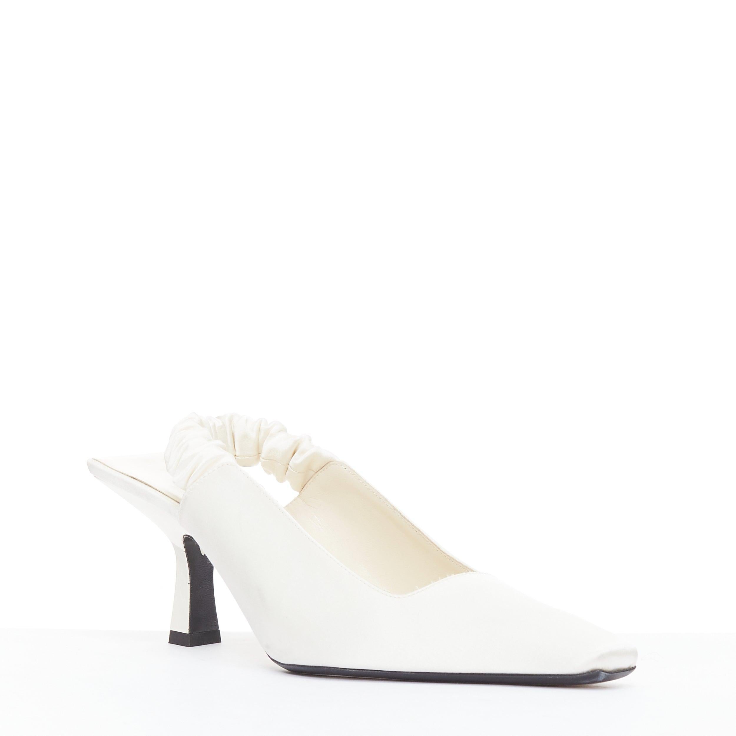 KHAITE Celaya ivory satin scrunch slingback square toe spool heels EU37
Reference: KYCG/A00110
Brand: Khaite
Model: Celaya
Material: Satin
Color: Cream
Pattern: Solid
Closure: Slingback
Lining: Cream Leather
Extra Details: This architectural