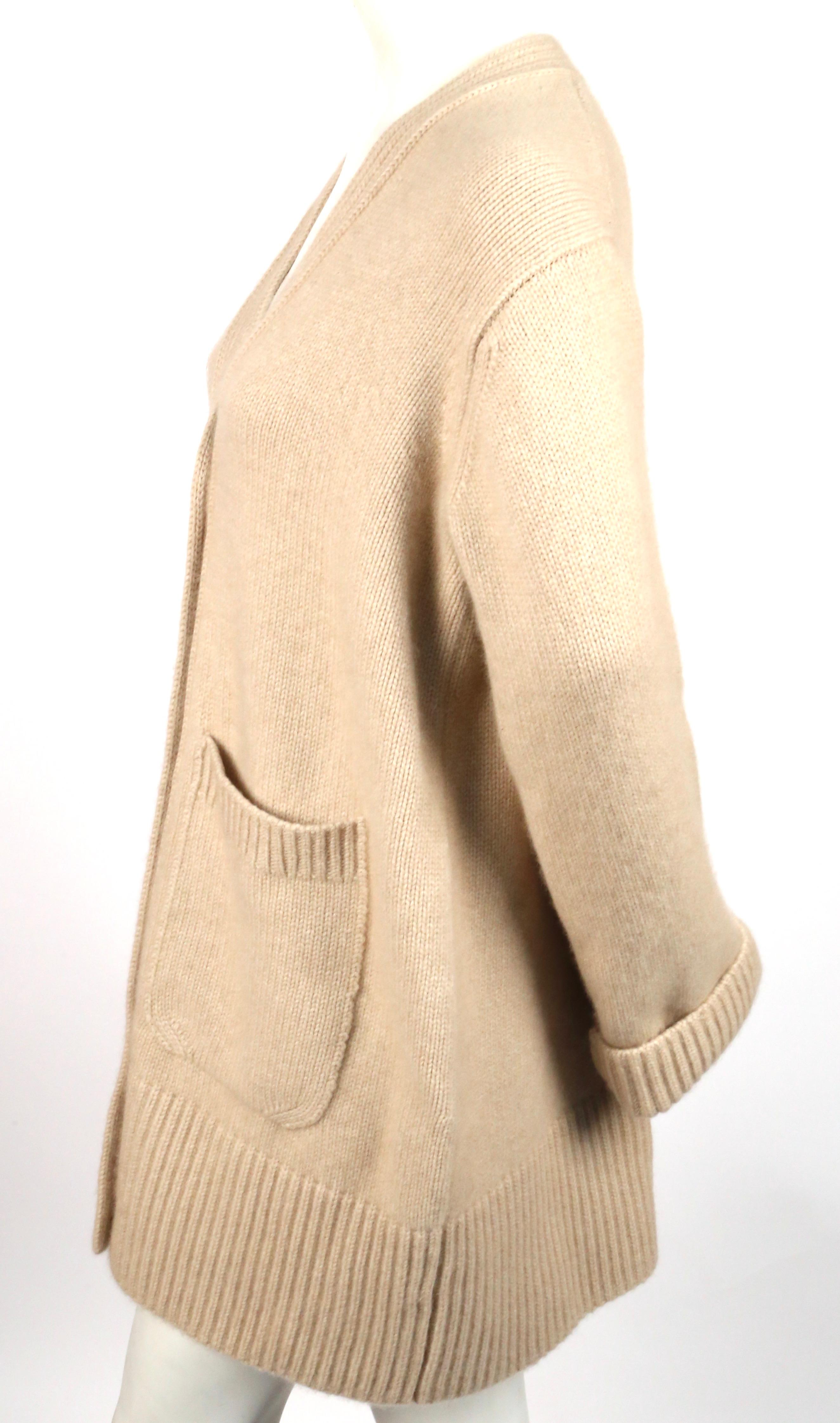 Oversized cashmere cardigan sweater with large patch pockets designed by Khaite. Color is 'butter'. New with tags. Fits a size S or M. Approximate measurements: Approximate measurements: bust 45-46