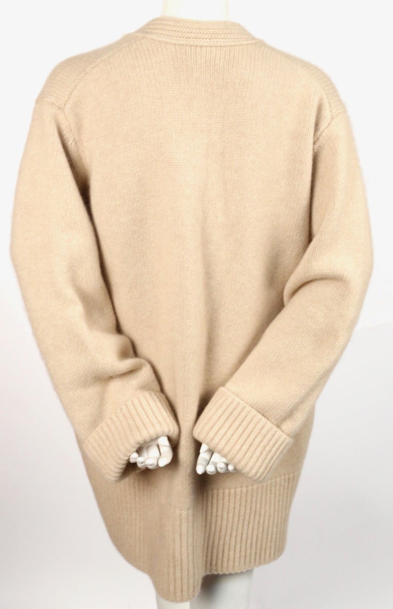 KHAITE 'LUCIA' oversized cashmere cardigan sweater with patch pockets in sand KHAITE 'LUCIA' oversized cashmere cardigan sweater with patch pockets in sand
