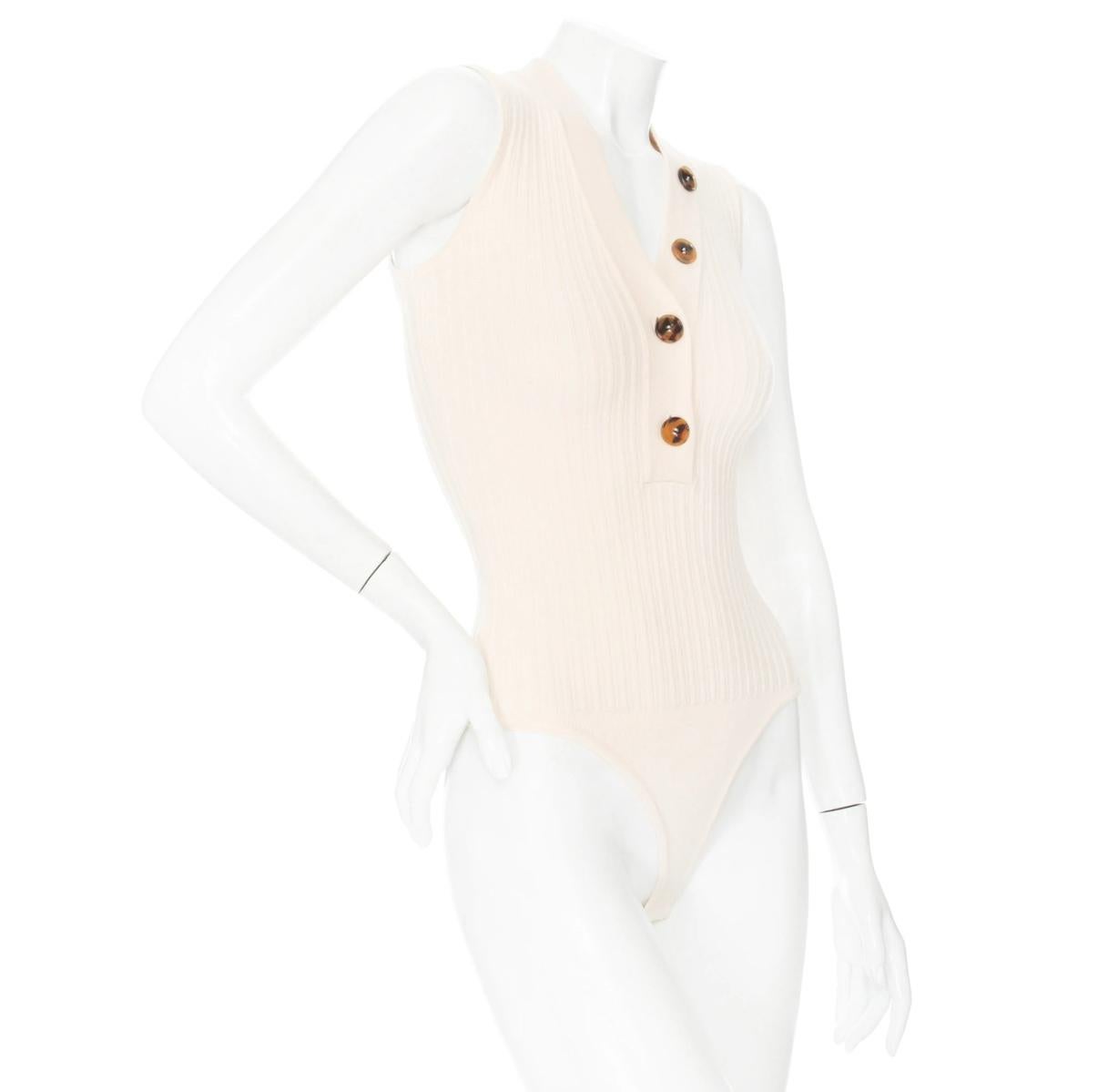 Khaite Cream Wool-Blend Knit Button Down Bodysuit

Beige / Tan
Ribbed knit
Sleeveless
V-neckline
Button down with partial closure
Snap closure at bottom
Made in Mongolia of Italian yarn
87% wool, 13% elastane
Great preowned condition; little signs
