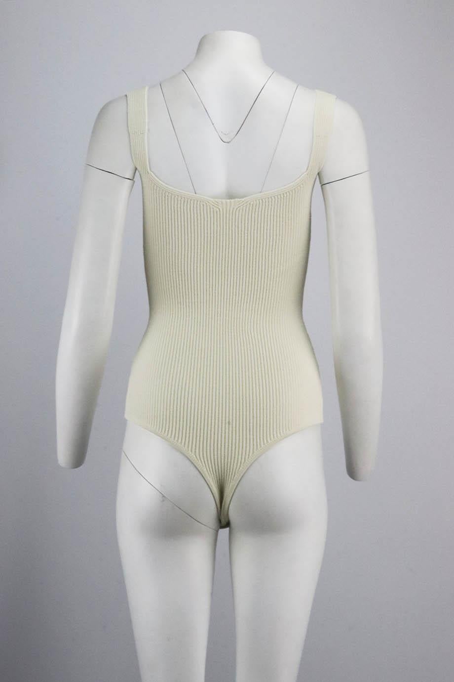 This bodysuit by Khaite has a notched sweetheart shape of this bodysuit works best with a delicate bra or gel petals, it's made from ribbed-knit chosen specifically for its stretch and structure. Cream viscose-blend. Snap button fastening at base.
