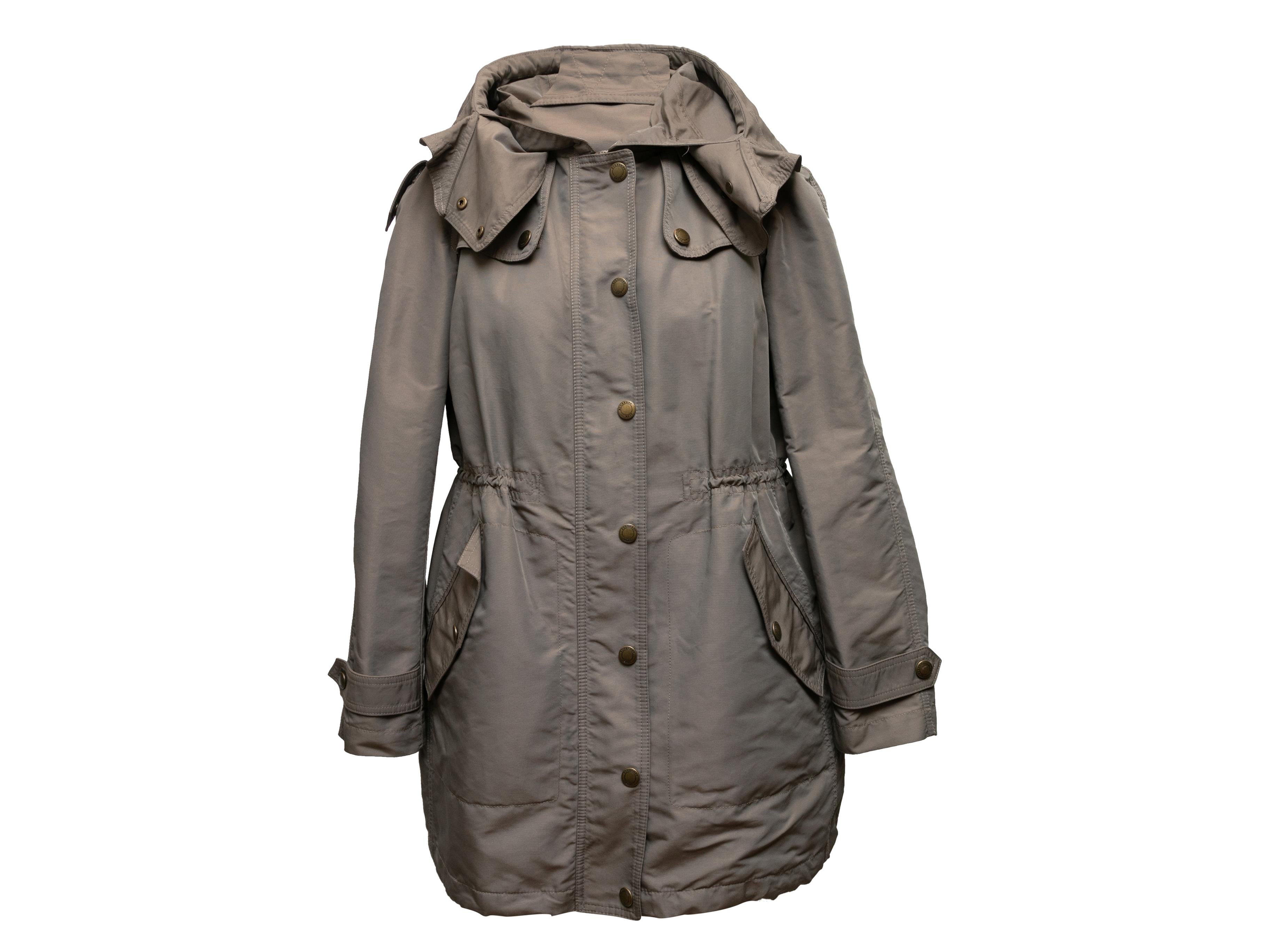 Khaki hooded nylon coat by Burberry Brit. Dual hip pockets. Zip and snap closures at center front. 32