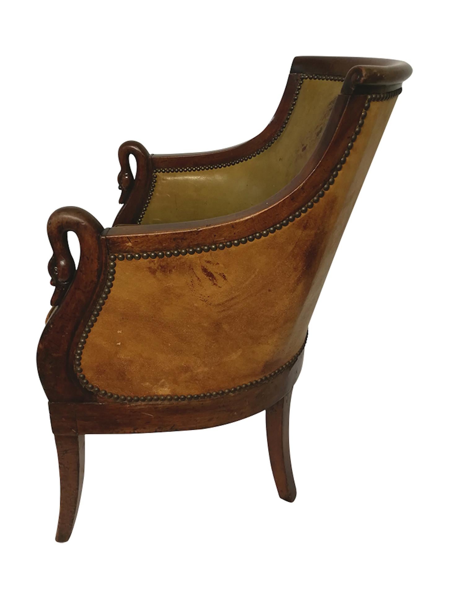 Beautiful and elegant Empire mahogany armchair with studded green leather upholstery and armrests carved 