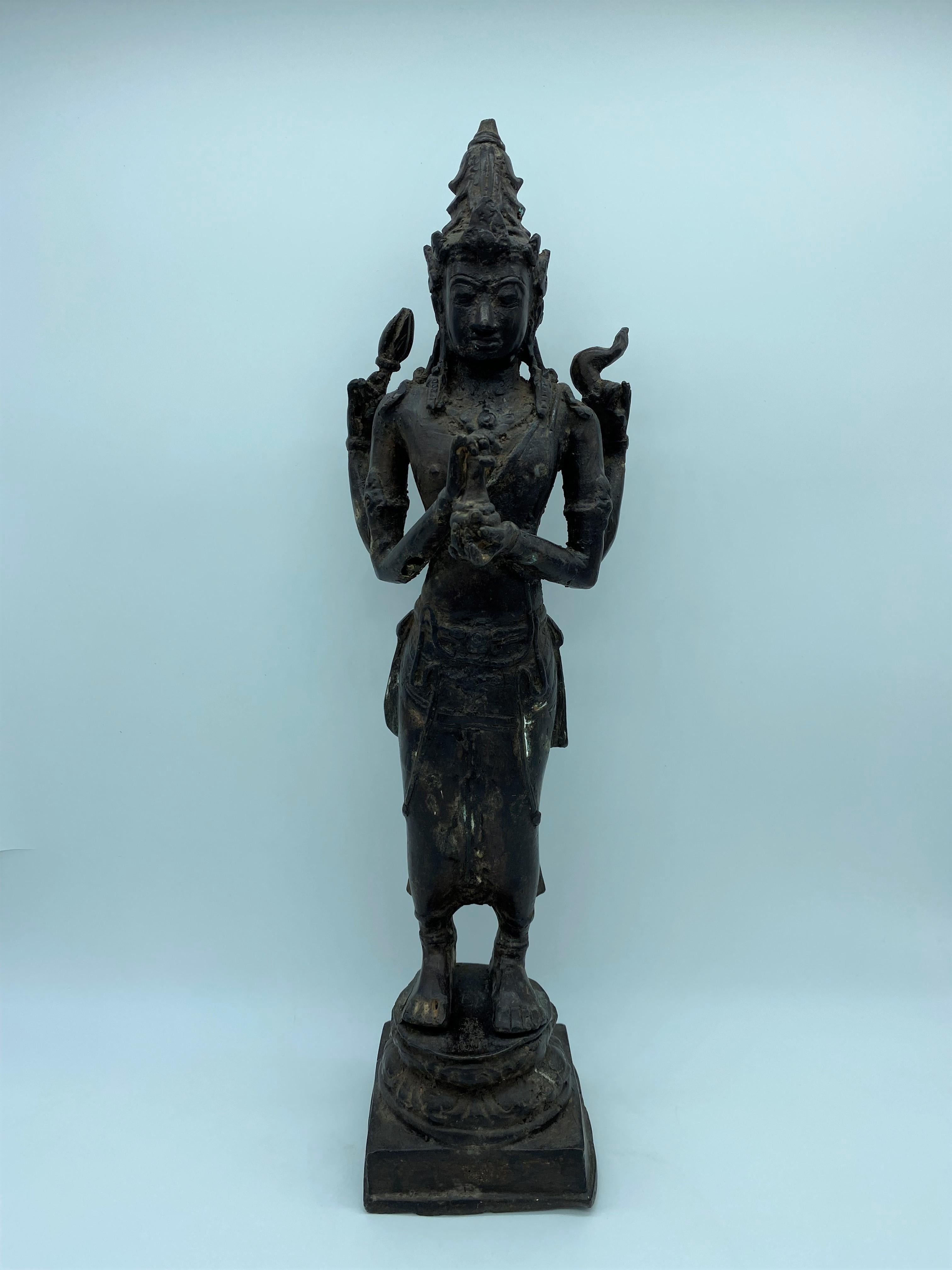 Very beautiful realization of a chiseled bronze deity of the Khmer art in Cambodia, a production of the 20th century. 
This statue probably represents the deity Vishnu, part of the Brahmanic triad (composed of Shiva, Brahma and Vishnu). He holds in