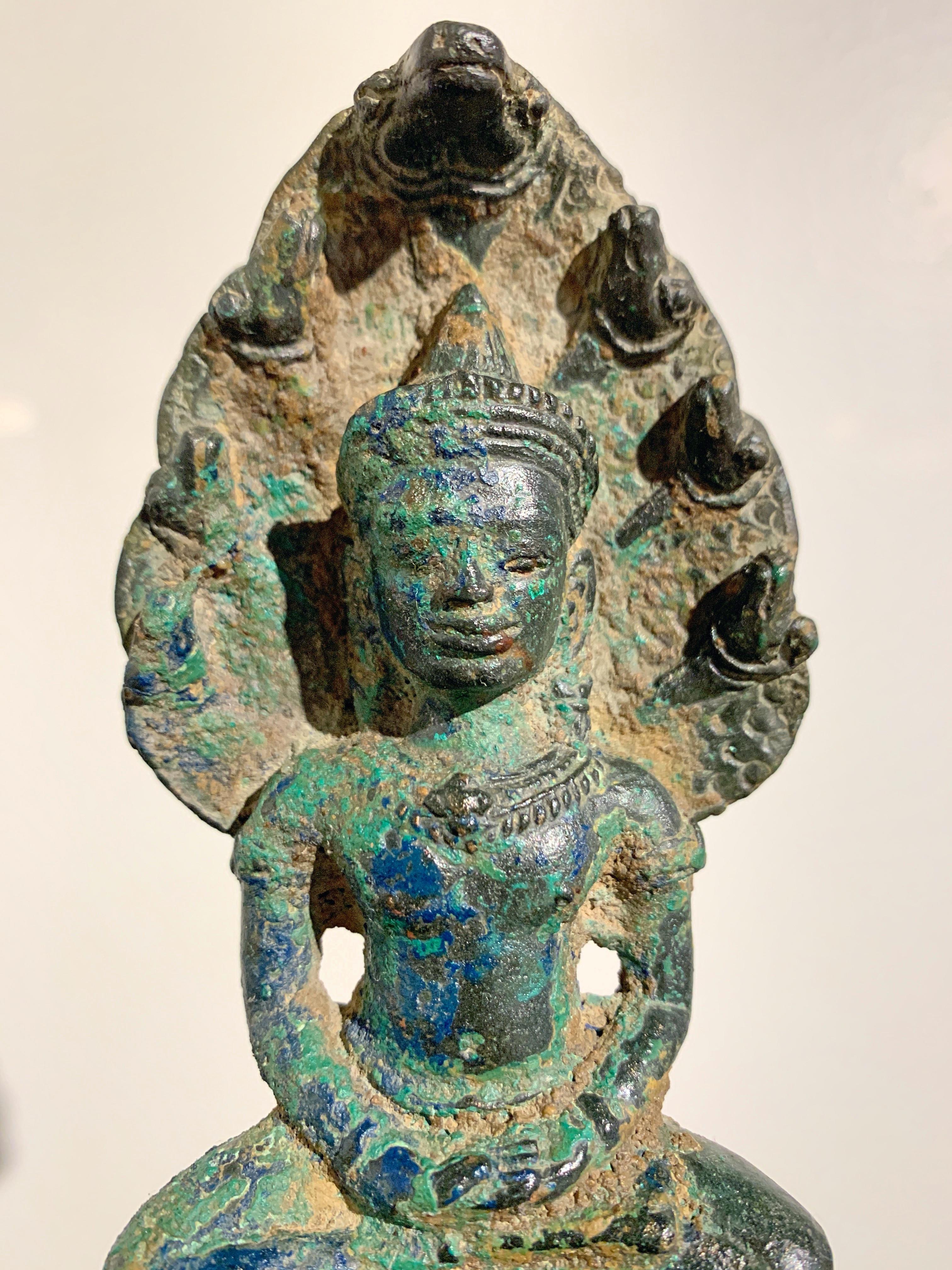 Khmer Bronze Buddha with Naga, Angkor Period, Style of the Bayon, 14th Century In Fair Condition In Austin, TX