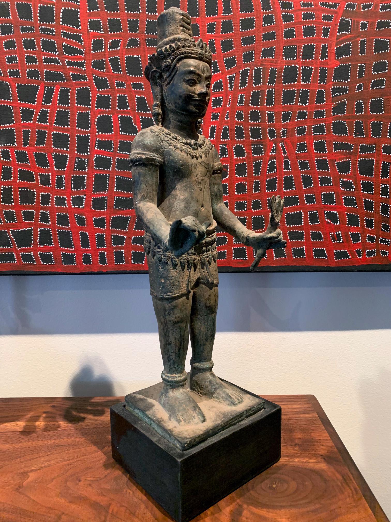 Khmer art of Cambodia was heavily influenced by Hinduism before it was infused with Theravada Buddhism in 13th-14th century. This bronze sculpture depicts male deity Vishnu, the Hindu God of Preserver. The image was cast only with two arms instead