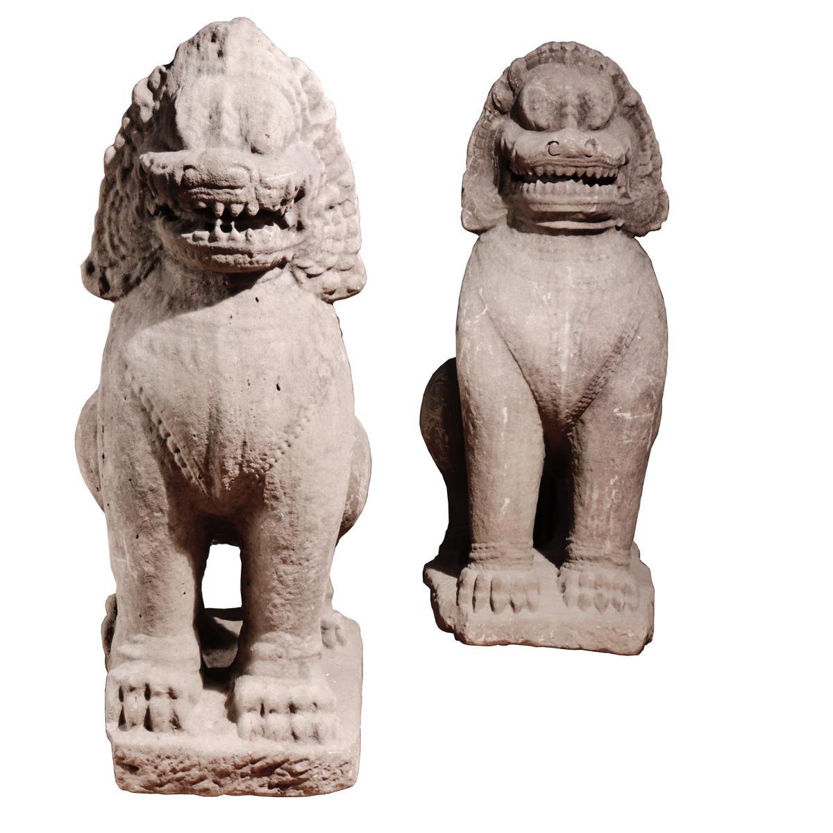 Khmer pair of Sandstone Guardian lion sculptures, Bayon style, Angkor period. Both fierce lions poised on a rectangular block with well-defined paws, half-sitting with a ridge line down centre of the back, ferocious expression with mouth open and