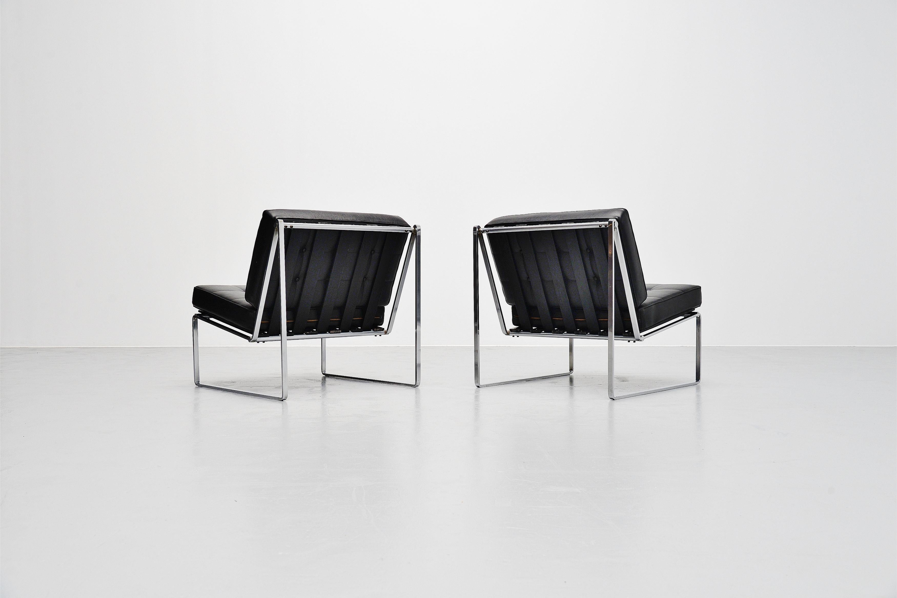 Comfortable pair of minimal lounge chairs model 024 designed by Kho Liang Ie and manufactured by Artifort, Holland 1962. These chairs have a solid metal, matt chrome plated sled frame. With black lacquered wooden slats, finished with leatherette