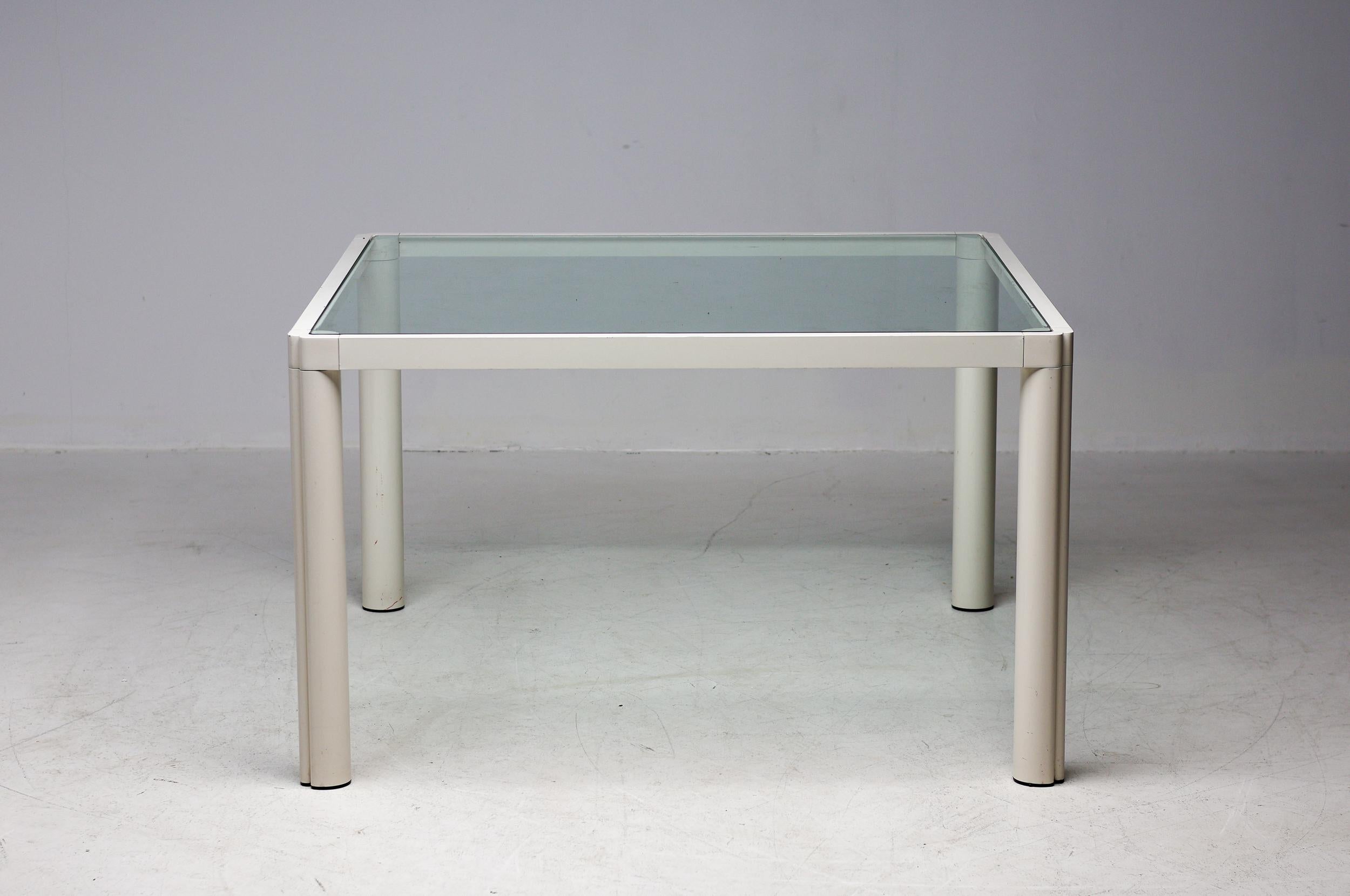 Monumental square dining or conference table in cast aluminum and smoked glass, designed by Kho Liang Ie for Artifort. Hightech lightweight off-white enameled aluminum frame with friendly rounded corners.
This very rare table resembles designs by