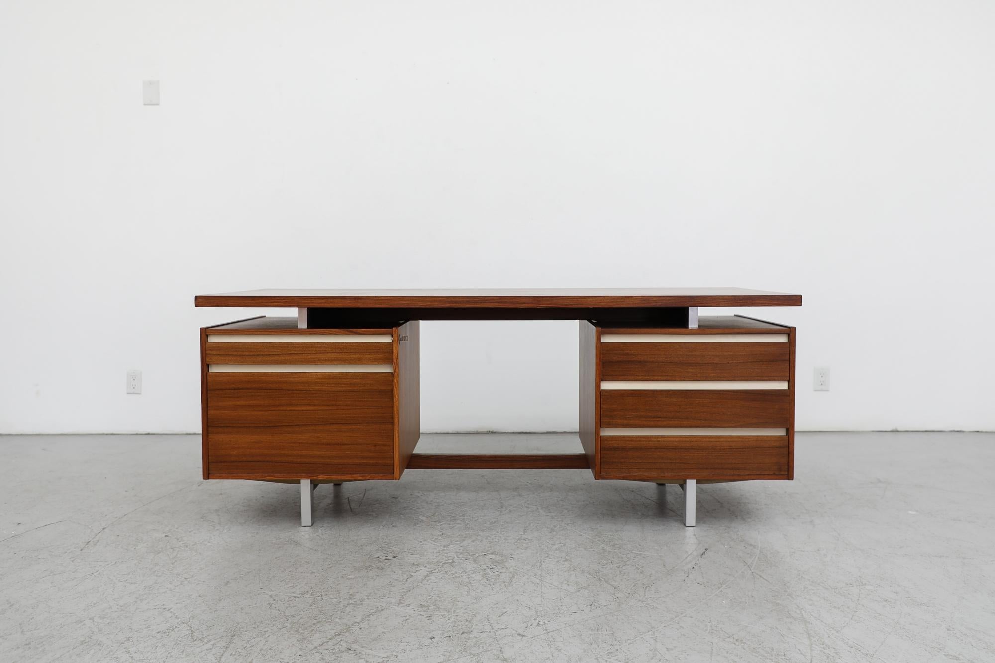 Mid-Century, Kho Liang Ie designed executive J desk from the J series, produced by Dutch furniture manufacturer Fristho from 1956 to 1960. Kho Liang Ie was born in 1927 in Magelang, Dutch East Indies. After Indonesia's independence in 1949, the