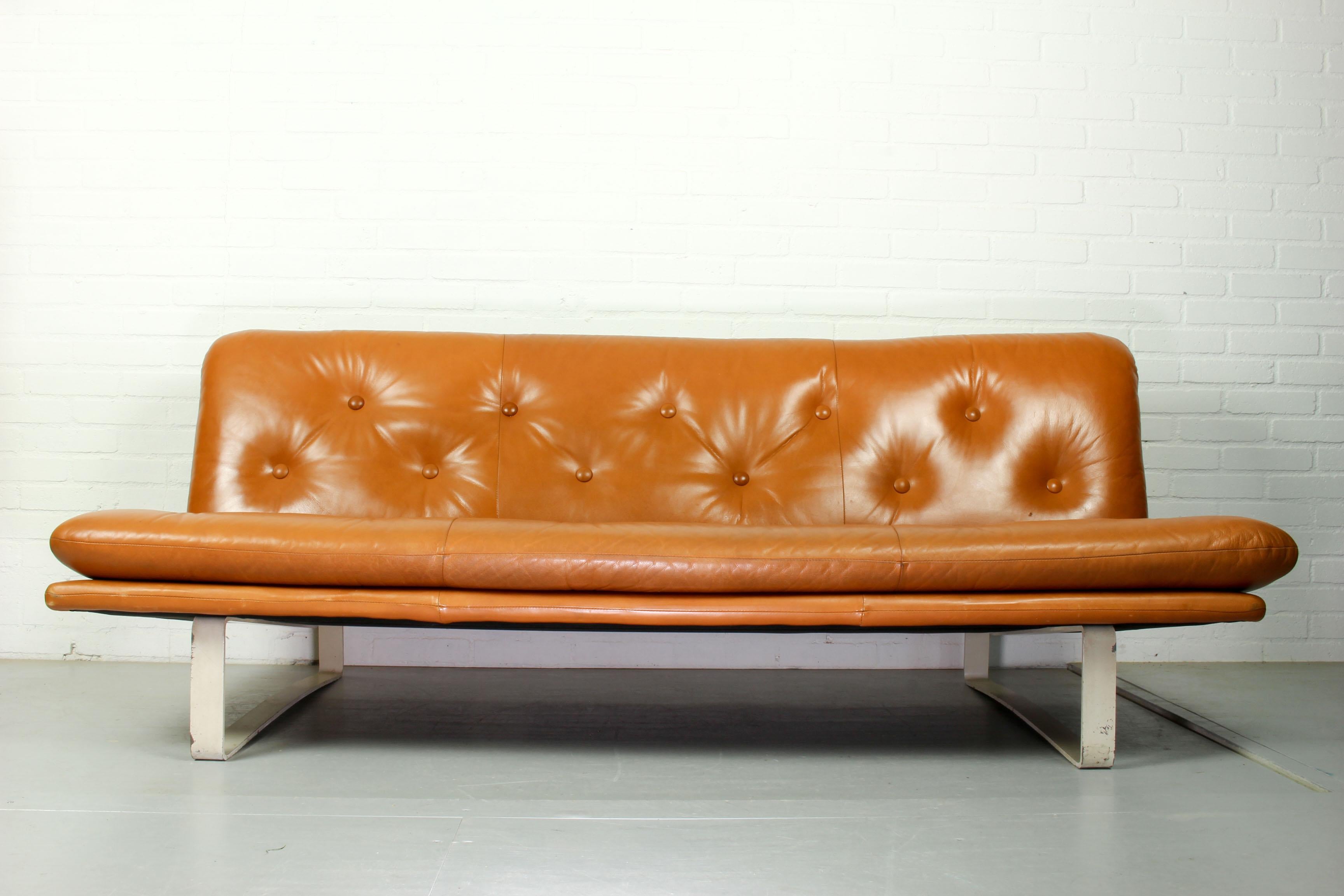 Kho Liang Ie for Artifort model C684 sofa, The Netherlands, 1968. Cognac brown leather sofa with an off white metal frame.