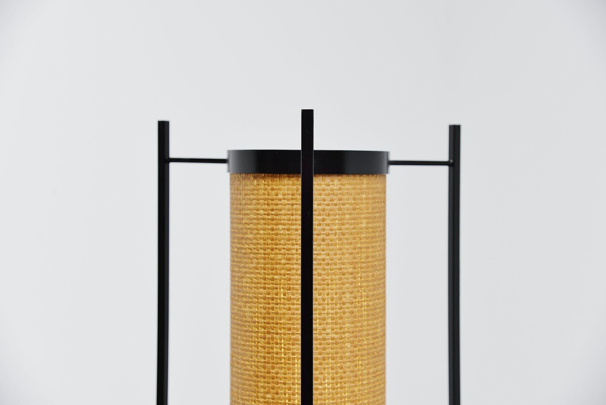 Magnificent modernist floor lamp model K46 designed by Kho Liang Ie and manufactured by Artiforte, Holland 1957. This very hard to find lamp has a very nice Japanese minimalistic look, 3 square black lacquered solid metal bars holding a rattan shade