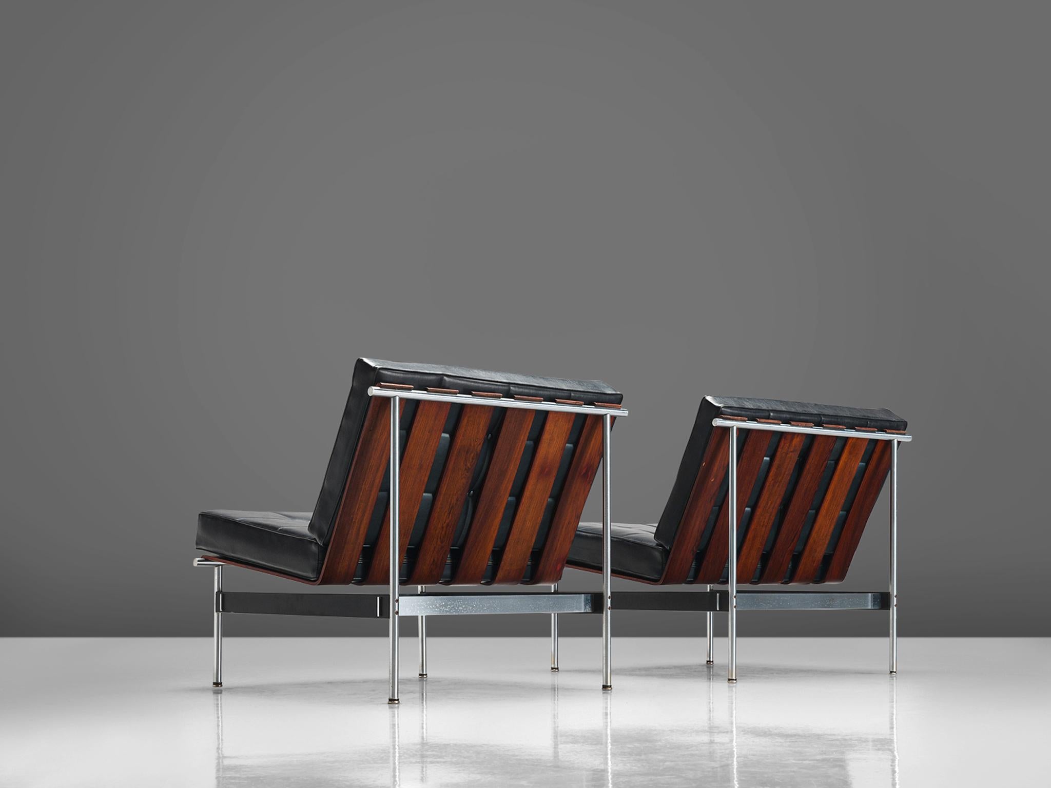 Kho Liang Ie for Artifort, easy chairs, rosewood, metal, black faux leather, the Netherlands, 1959.

The design of these lounge chairs modern, simplistic and features a combination of materials that were specific for that time. The chair is made out
