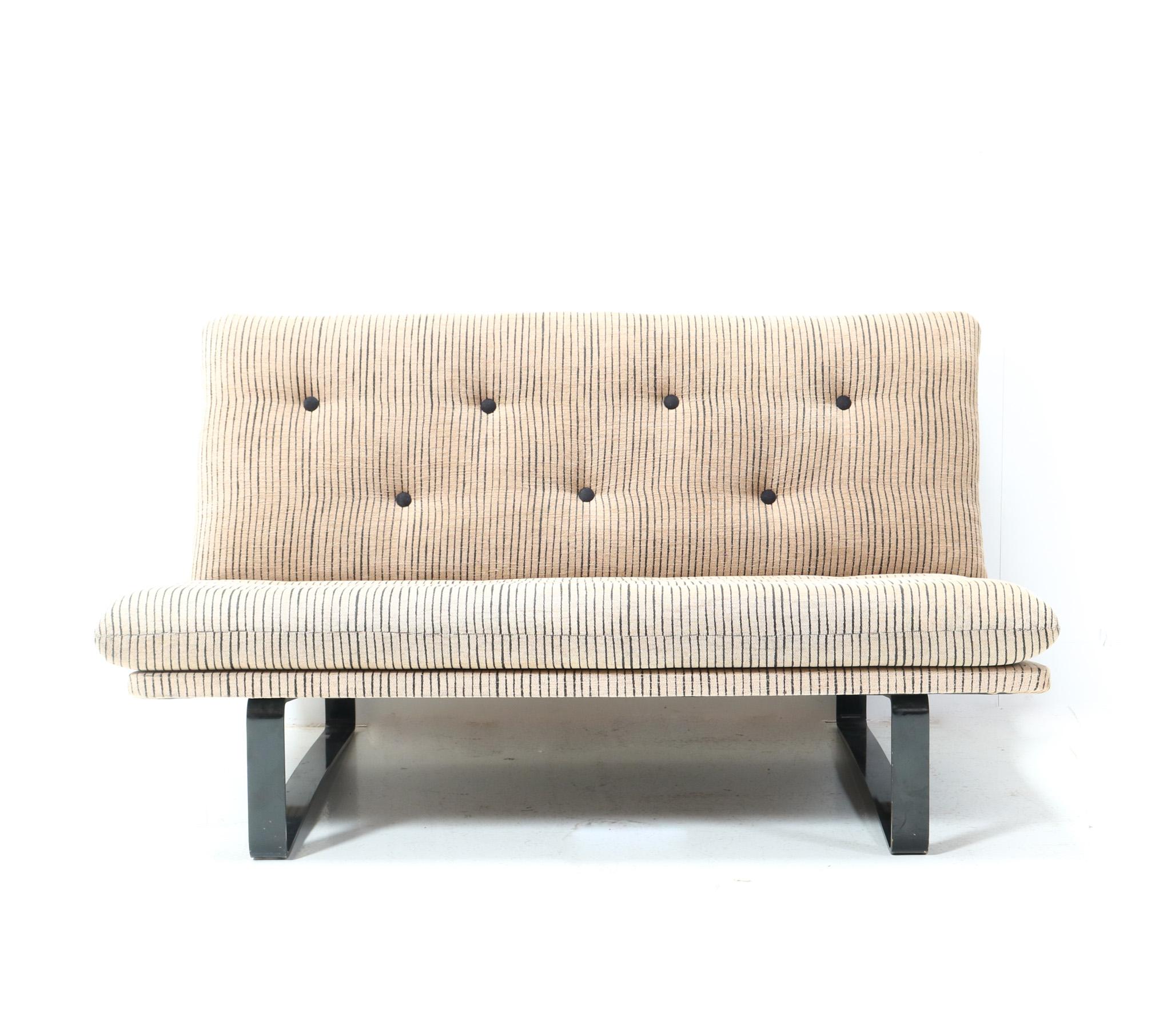 Stunning Mid-Century Modern C683 two-seater sofa or settee.
Design by Kho Liang Le for Artifort.
Striking Dutch design from the 1960s.
Original black lacquered metal frame with original tufted upholstery.
This wonderful Mid-Century Modern C683