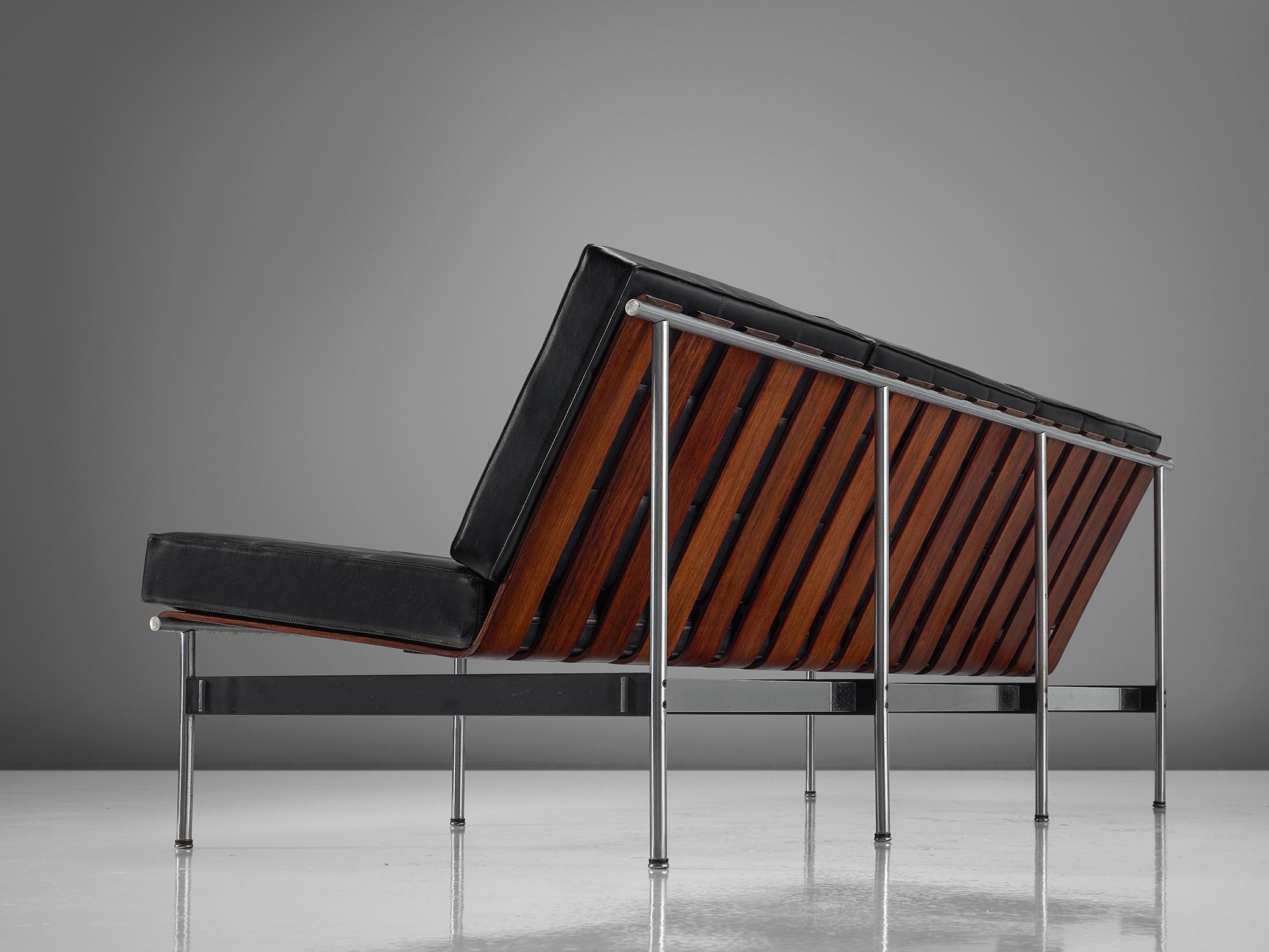 Kho Liang Le for Artifort, sofa, rosewood, metal, black faux leather, the Netherlands, 1959.

The design of this sofa is simplistic and features a combination of materials that were specific for that time. The sofa is made out of rosewood slats in