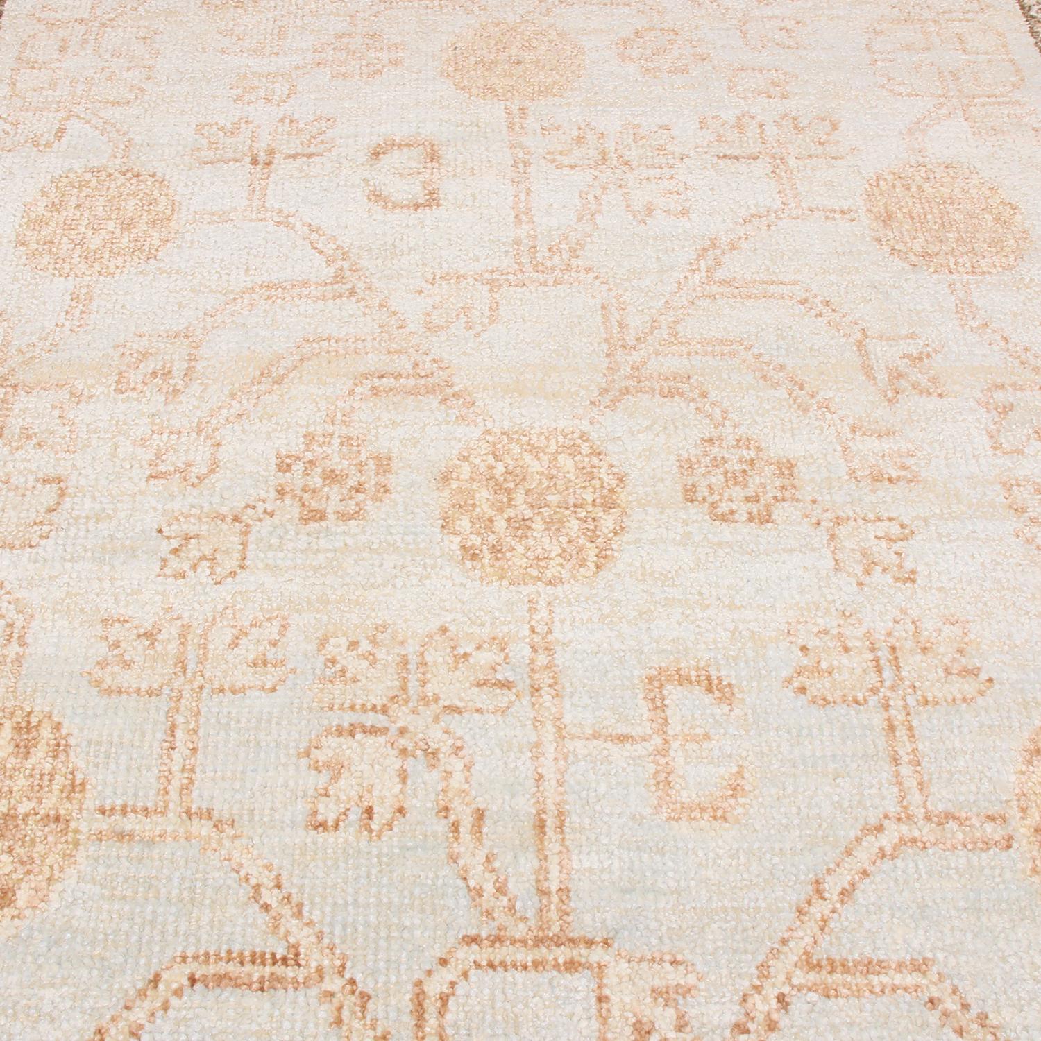 Hand knotted with high-quality wool and complementary silk originating from India, this Khotan rug employs a unique series of influences from antique and vintage rugs of the same family, seen in its blissfully intricate design marrying the