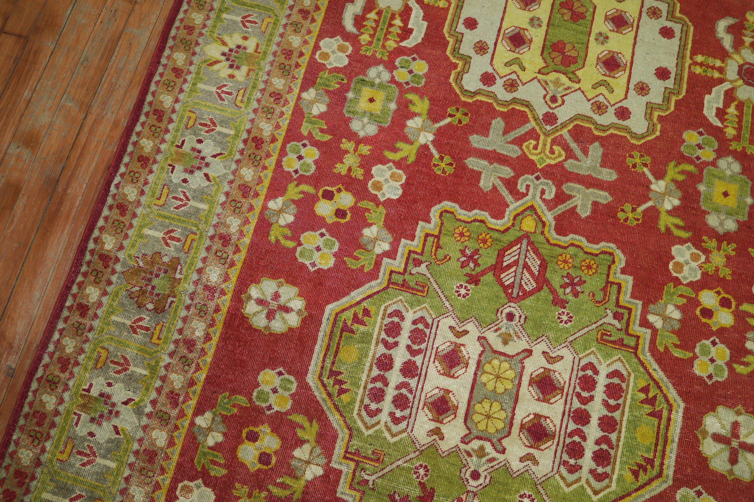 A colorful fine quality early 20th century antique Khotan rug in vivid red, green and yellow accents

Measures: 5'3