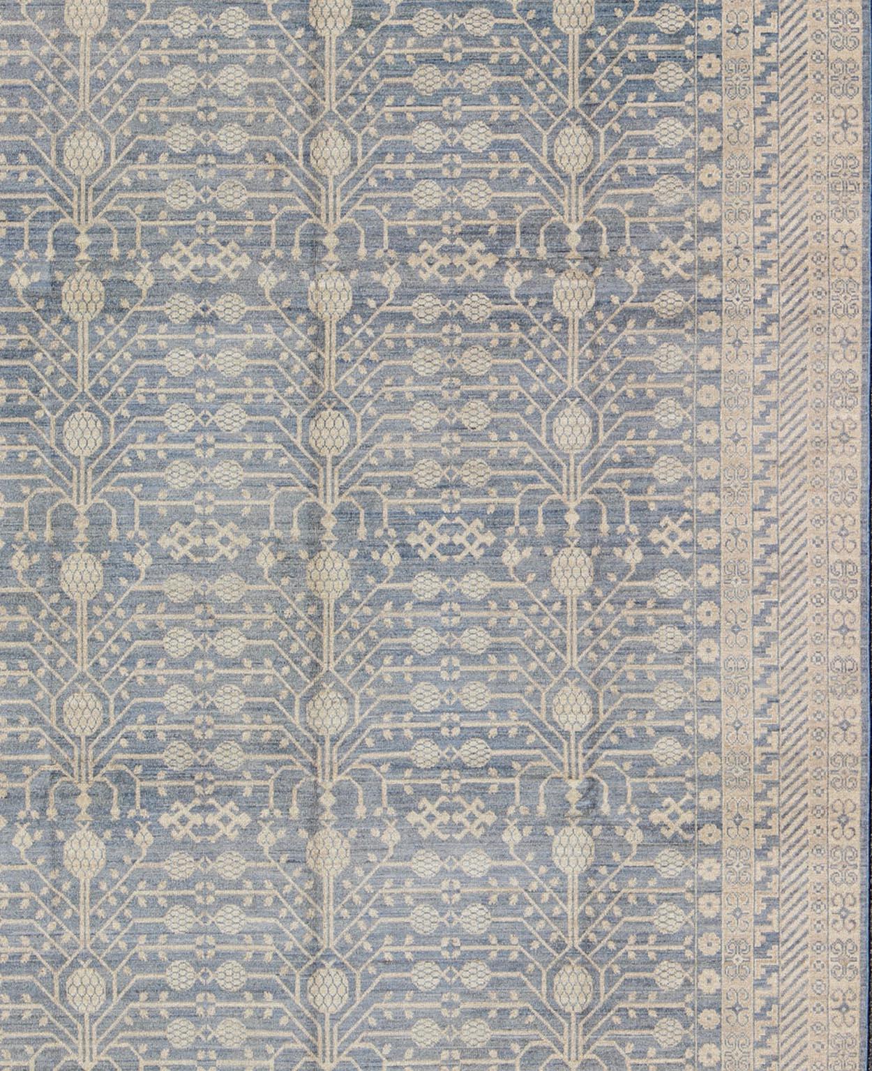 Dieser Khotan weist ein Allover-Muster auf, das von einem sich wiederholenden Muster in der Bordüre mit asiatischen Motiven flankiert wird. Das gesamte Stück ist in hellen Tönen gehalten, was es zu einem vielseitigen Teppich macht, der sich gut für