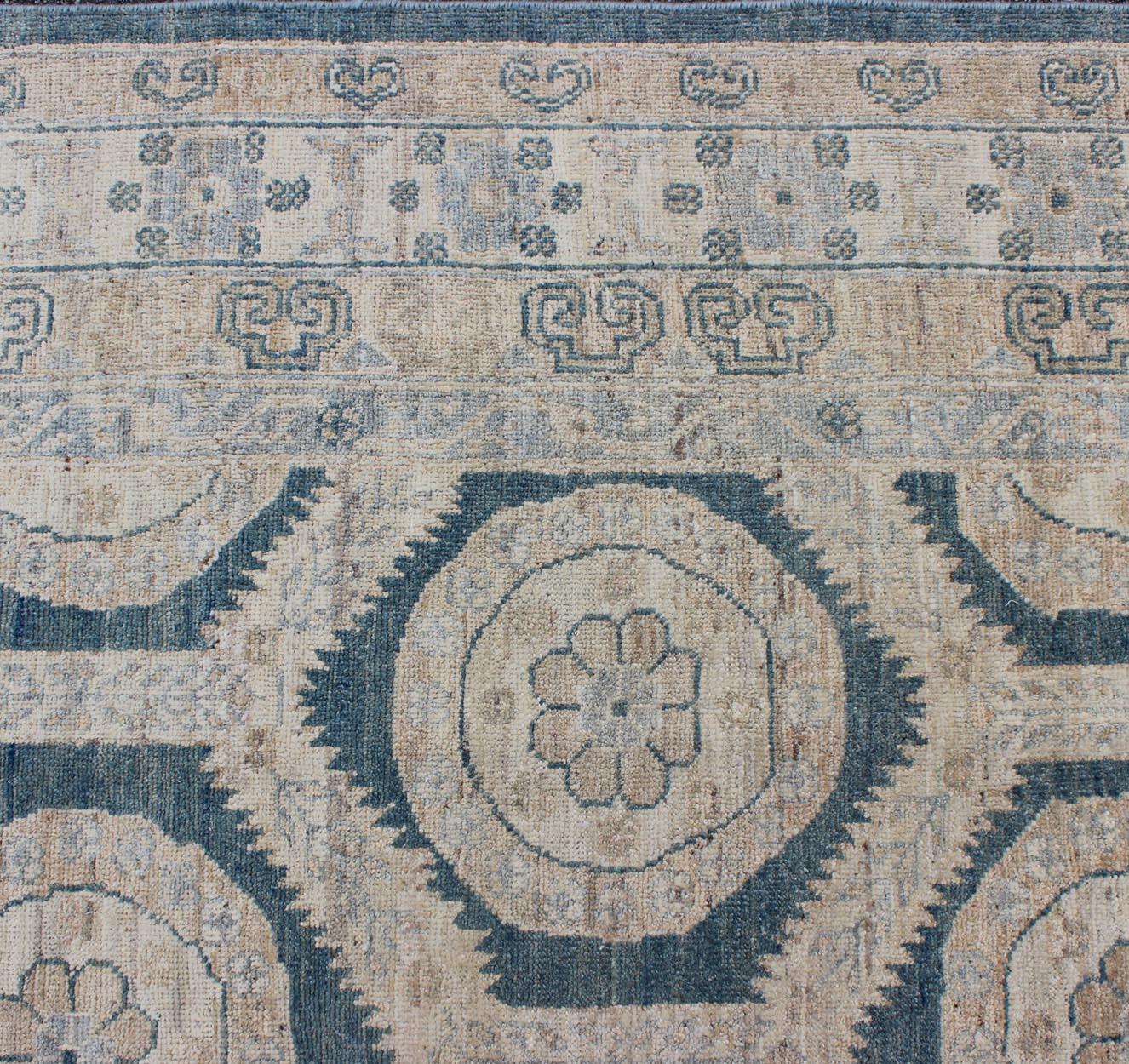 Khotan design rug with geometric medallions in tan, blue gray & teal blue. Khotan rug MP-1504-3391, country of origin / type: Afghanistan / Khotan.

Measures: 8'2 x 9'10.