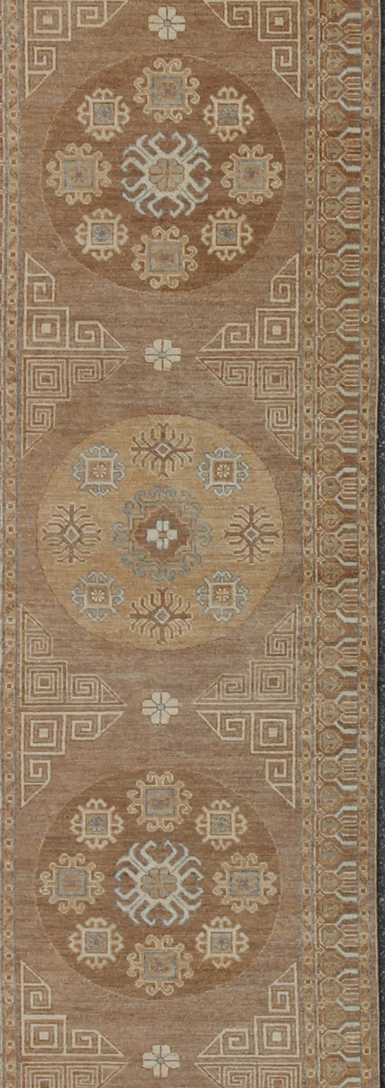 Light Khotan runner with geometric Medallions, rug/MP-1703-1743 country of origin / type: Afghanistan / Khotan

This Khotan features a geometric all-over circle design flanked by a repeating pattern in the border. The entirety of the piece is