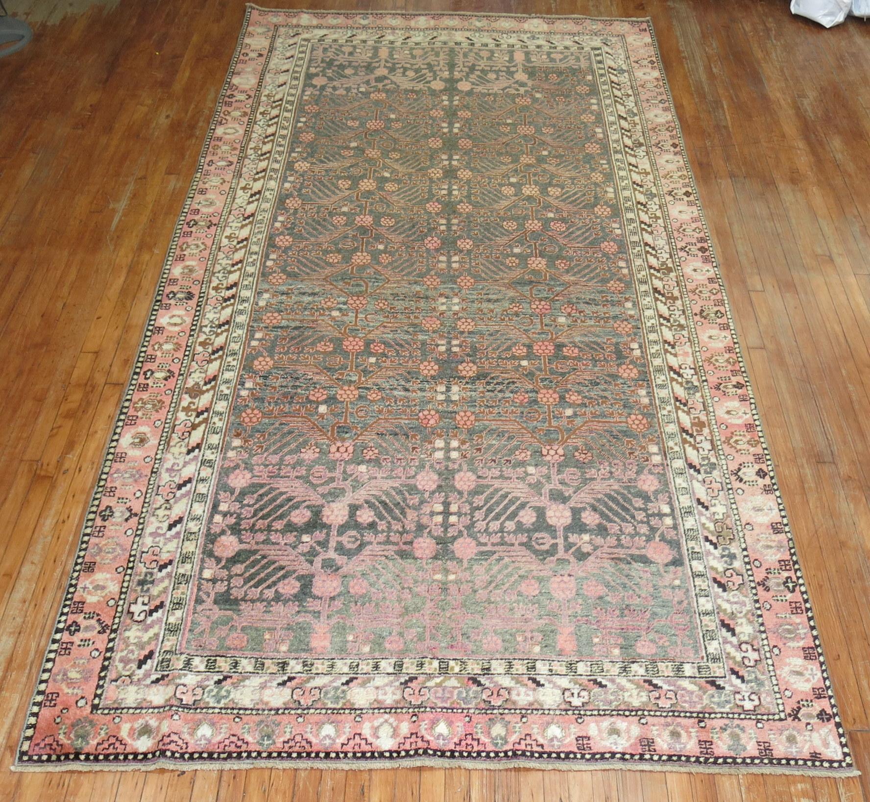A high Decorative Khotan Gallery size rug with a pomegranate motif on a gray field. Overall even medium pile condition

circa 1920, measures: 6'7