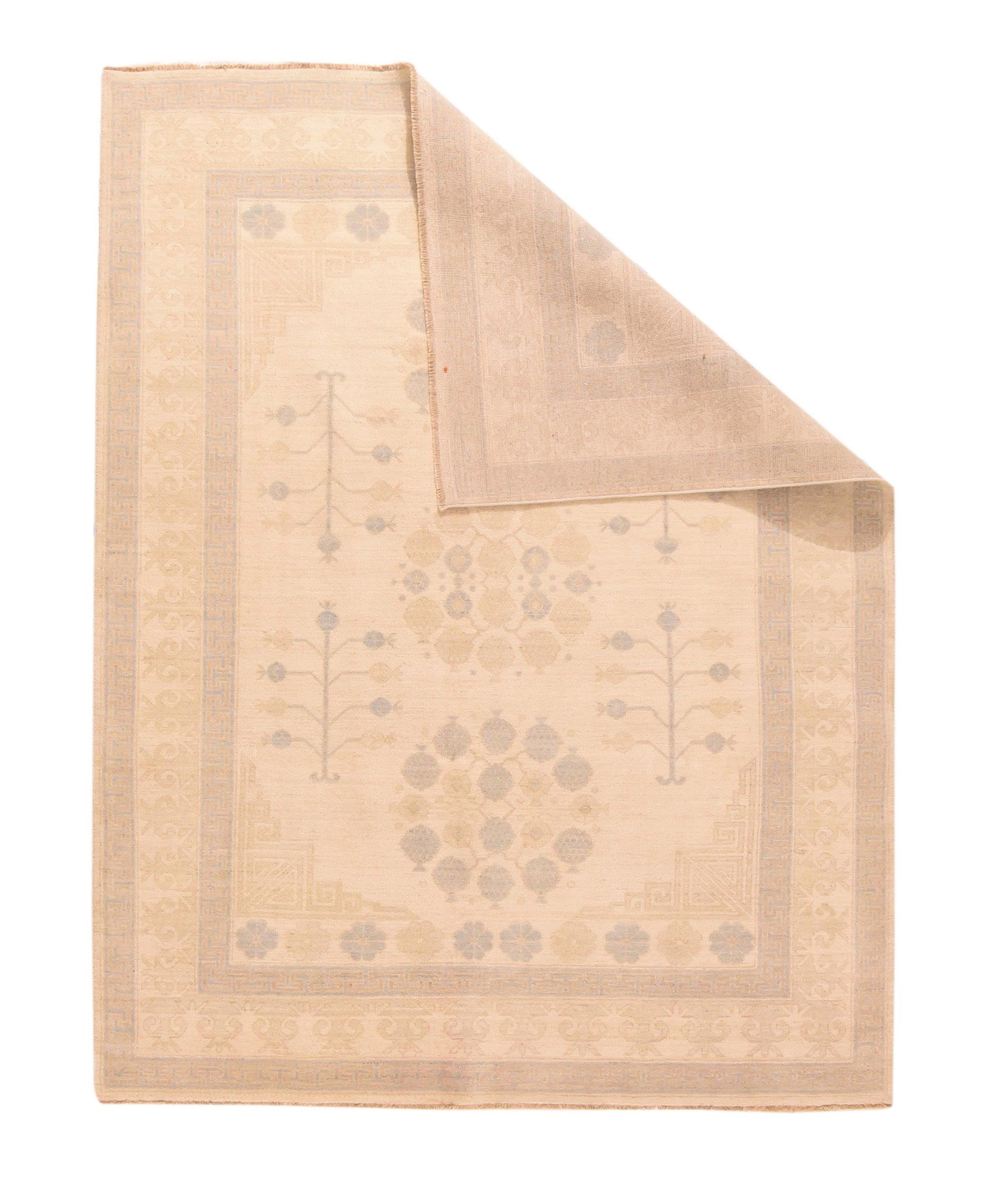 Khotan Rug 5'6'' x 7'9''. The straw-sand field features three floating pomegranate circular wreaths, and four bare pomegranate trees alongside. Fret field corners and terminal rosette panels. Cream border with anthropomorphic vases. Moderate weave,