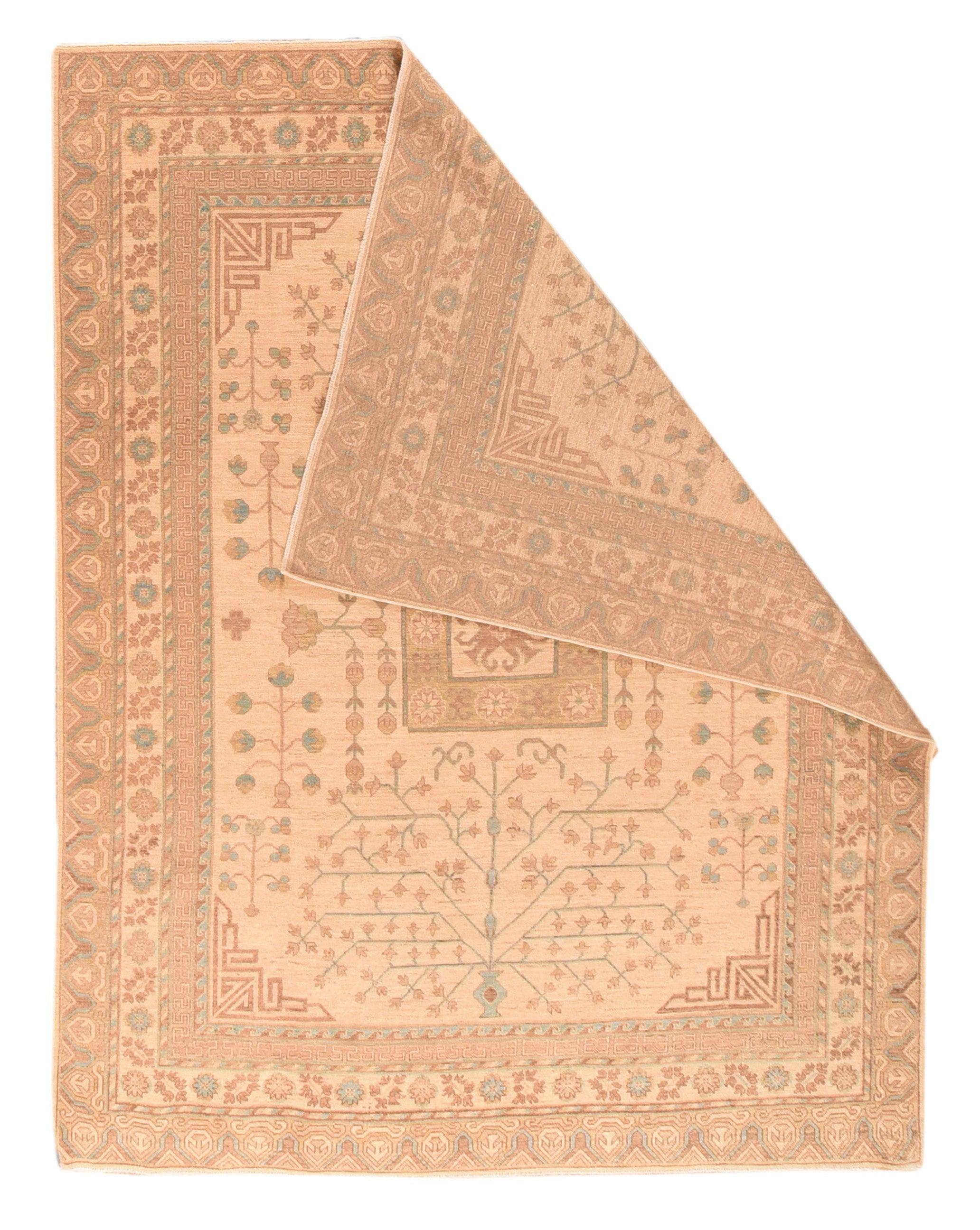 Khotan Rug 7'10'' x 9'10''. This Xinjiang Province, western Chinese carpet shows a desirable straw field centred by a square enclosing a stellate motif, and with vases and pomegranate trees at each end and wrapping around the field sides. Triangular