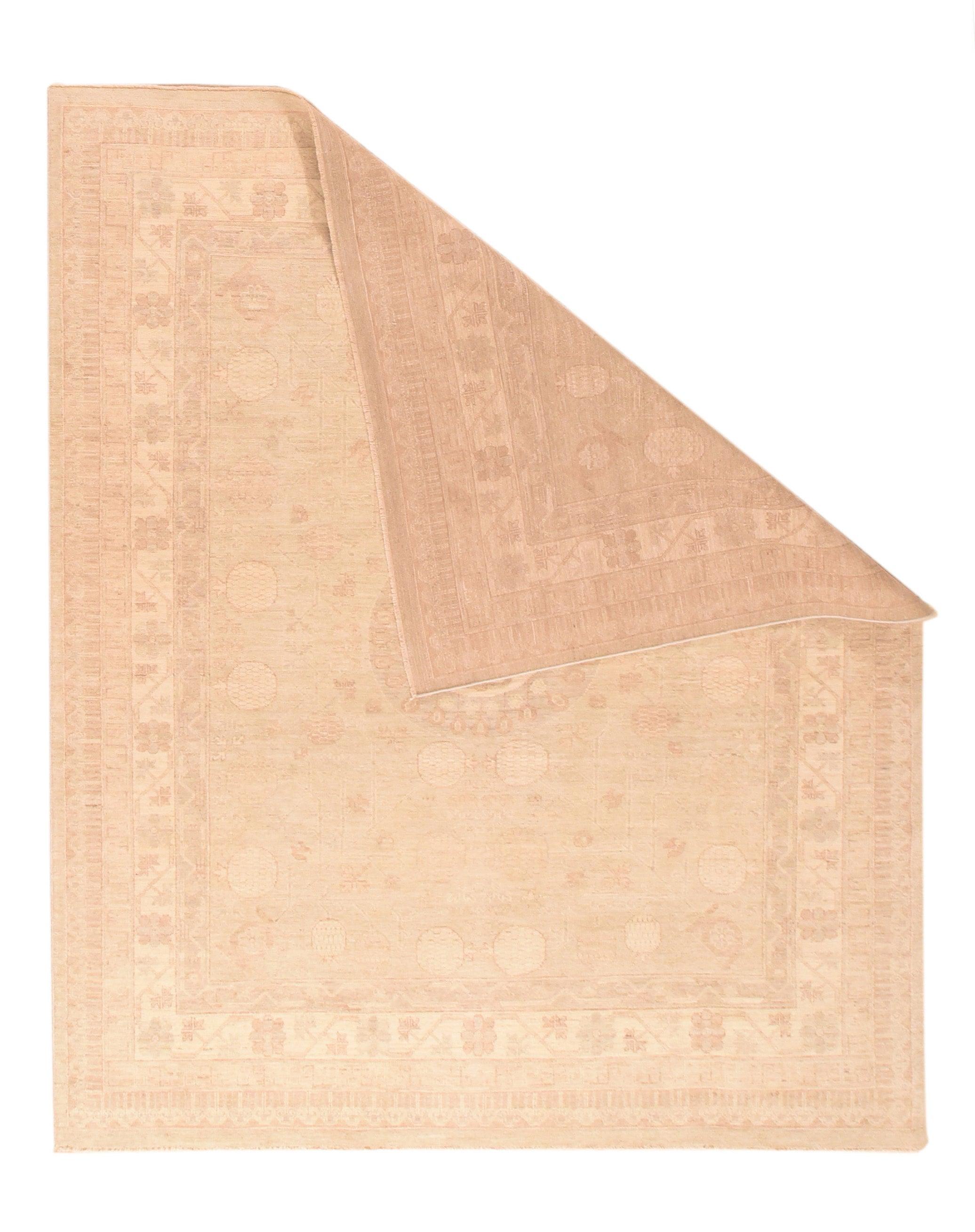 Khotan Rug 7'11'' x 9'9''. A layered round “moon” medallion is positioned by pairs of pomegranates above and below on the straw-khaki field. Additional pomegranate pairs at field ends Sandy cream Main border with flowering trapezoidal meander and