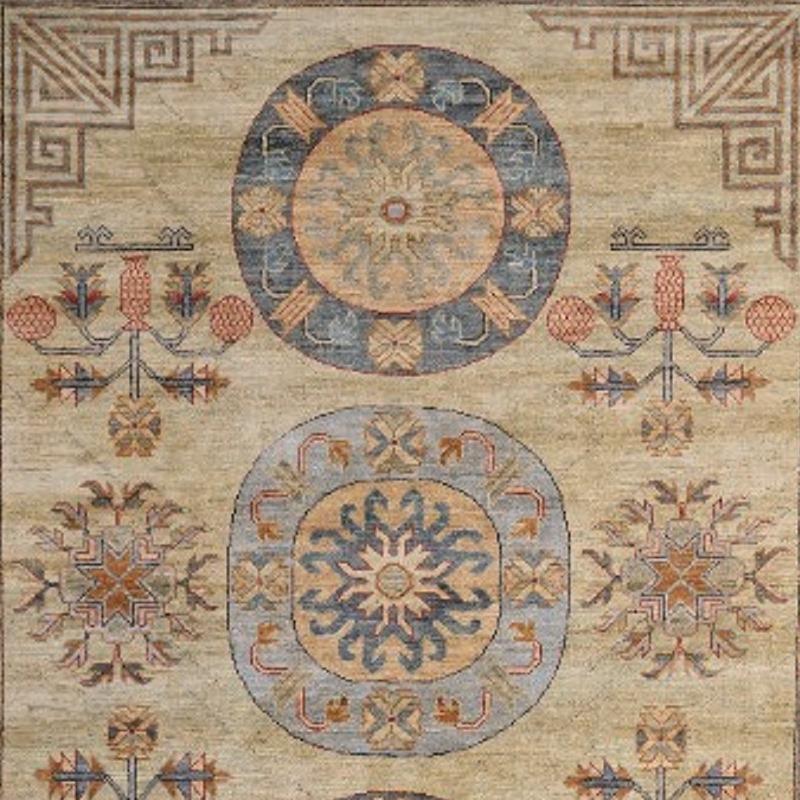 A medium sized rug with traditional Samarkand Khotan design. The pile is made of high end quality wool - hand spun, hand dyed with all vegetable dyes and knotted by master weavers. The rug is very decorative and has a towards square format. The