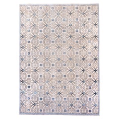 Tappeto Khotan con disegni a melograno e a reticolo ripetuti in blu e avorio.