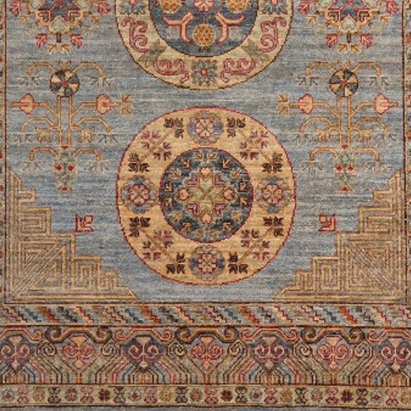 A circa 7 x 5 ft sized rug with a Khotan style design. The pile is made of high end quality wool - hand spun, hand dyed with all vegetable dyes and knotted by master weavers. The rug is very decorative and has a towards square format. The condition
