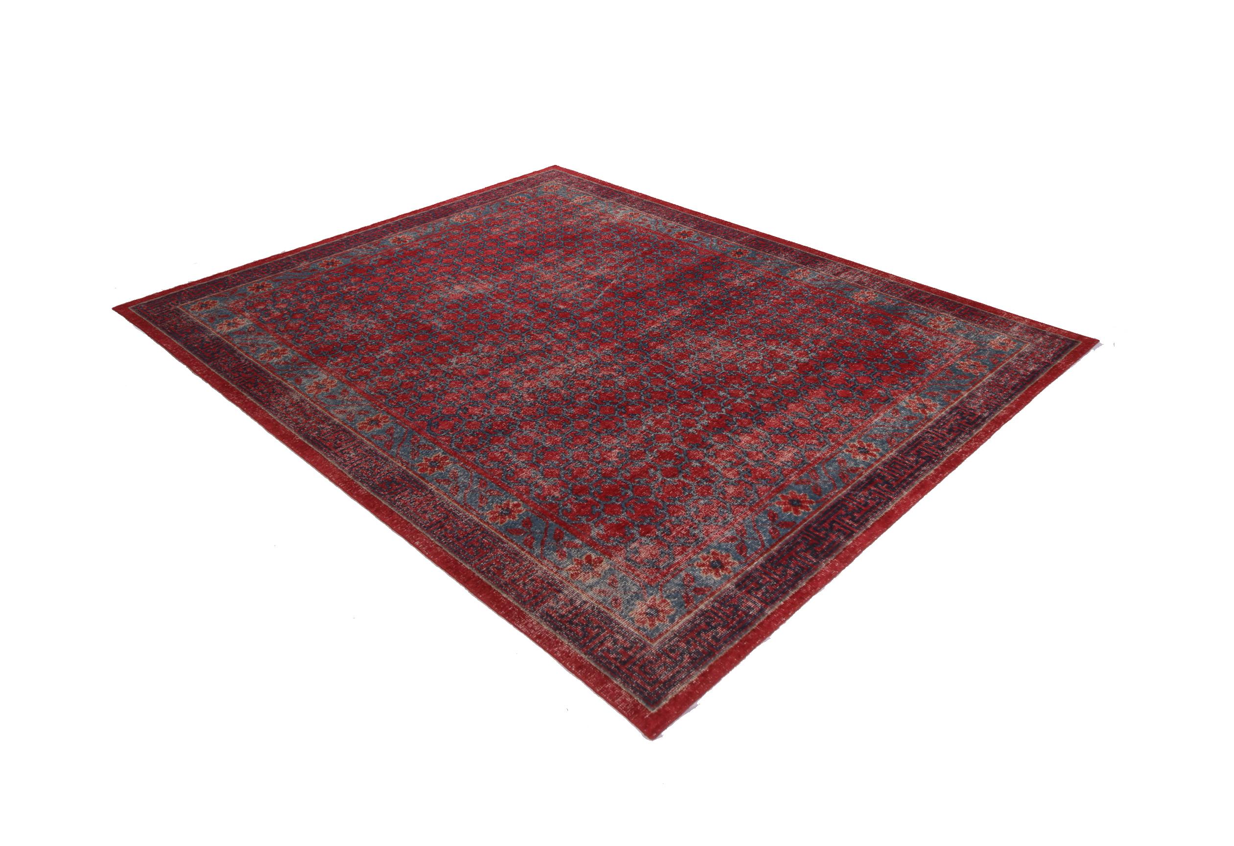 This contemporary hand knotted wool Khotan rug hails from Rug & Kilim’s Homage collection, enjoying a finer take on distressed shabby chic aesthetic with fewer knots per square inch. The bold velvet red and ink blue colorways complement a variety of