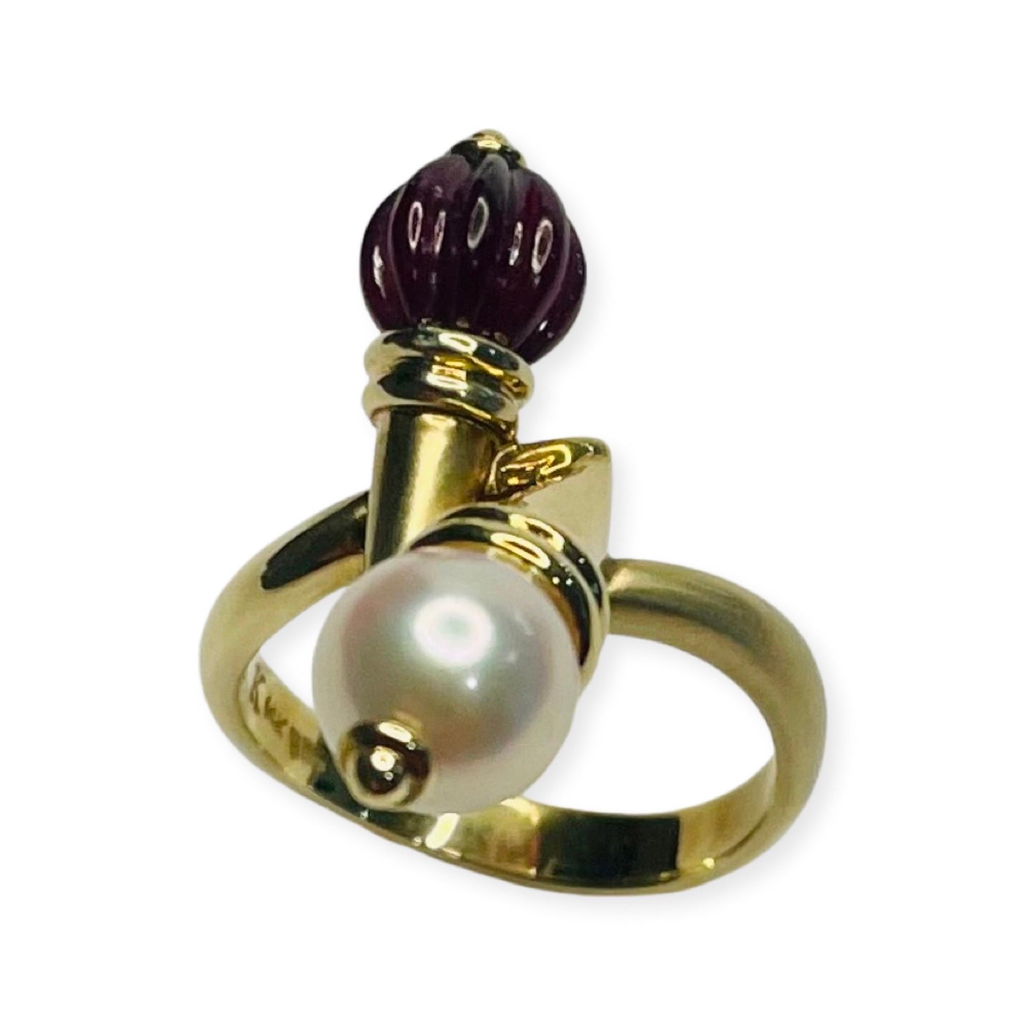 Kian 14K Yellow Gold Garnet and Cultured Japanese Akoya Pearl Ring. The garnet bead is 6.4 mm and the Japanese Akoya pearl is 7.3 mm. The pearl is round with high luster and slight blemishes. The shank is 3.2 mm at the top and tapers to 3.5 mm at