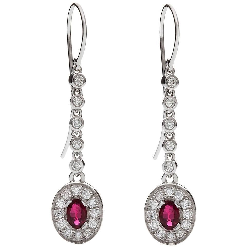 Rubino Earrings

This stunning pair of 18ct white gold earrings are destined to become treasured heirlooms. The rubies are each surrounded by petite pave' set diamonds and both settings are suspended from diamond set drops.

Oval faceted rubies: