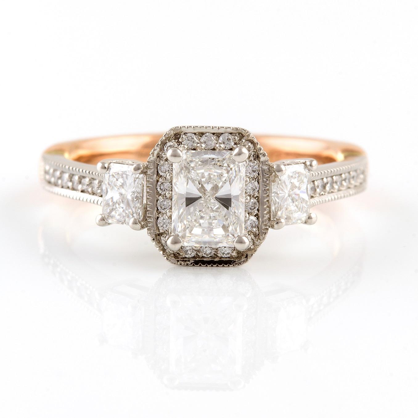 Platino Rosa Diamante Ring

This elegant handmade vintage style ring consists of a beautiful four claw set radiant cut diamond that is surrounded by petite round diamonds. Two smaller radiant cut diamonds are similarly four claw set on either side