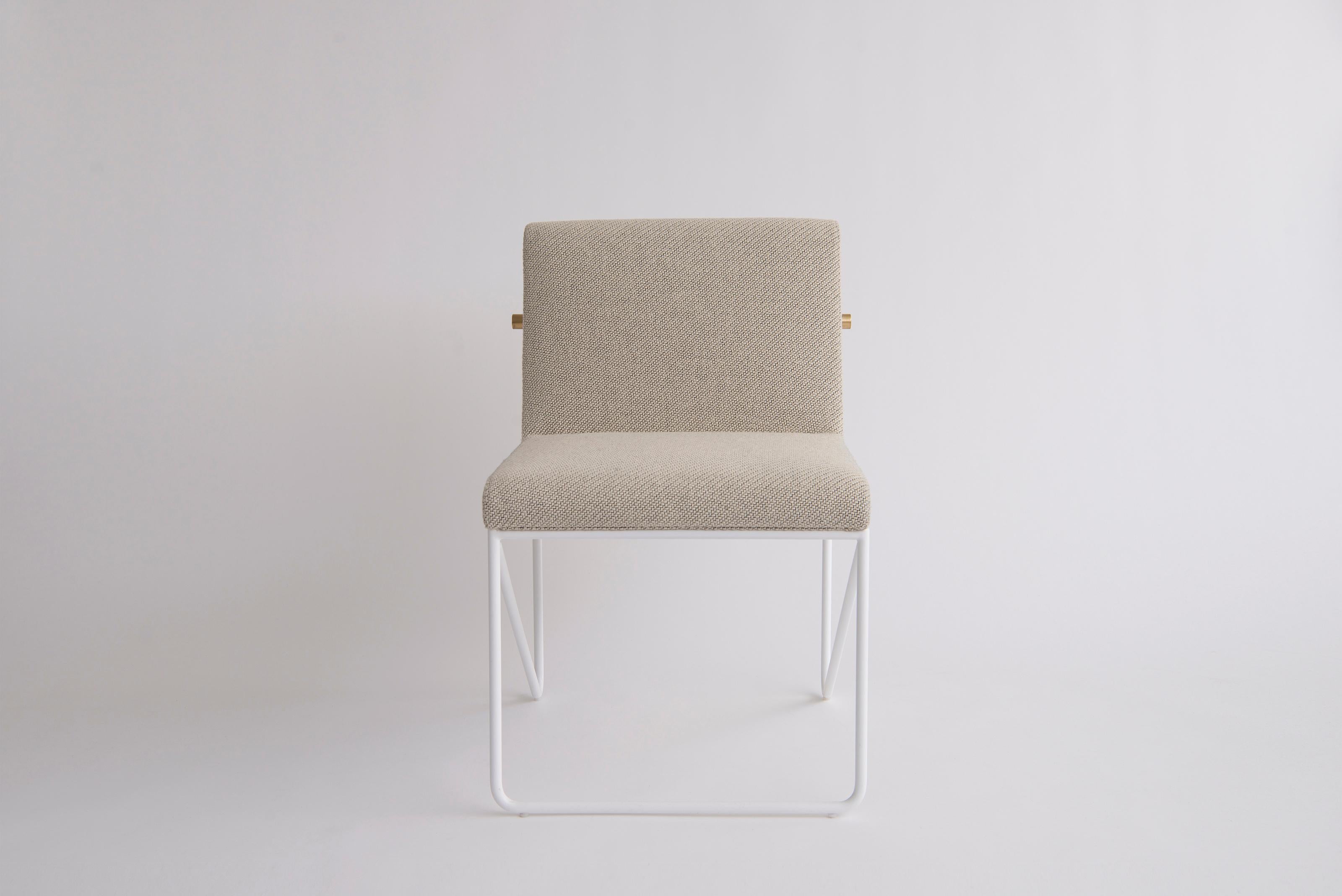 Kickstand Armless Side Chair by Phase Design
Dimensions: D 63.5 x W 55.9 x H 79.4 cm. 
Materials: Upholstery, powder-coated metal and brushed brass.

Solid steel bar available in a flat black or white powder coat finish with solid brushed brass bar