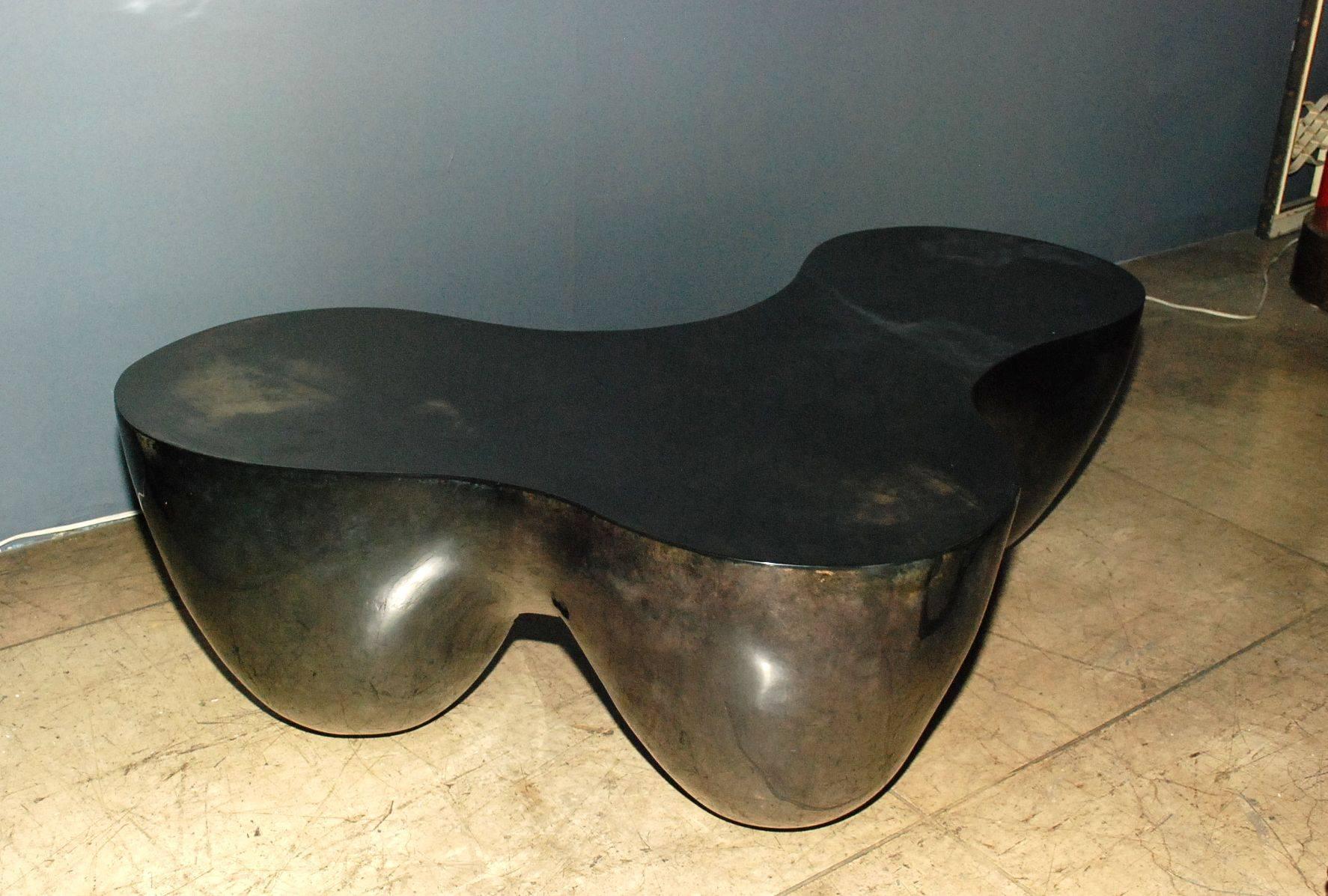 Coffee table cover with goatskin. Parchment is in varying shades of charcoal. (High gloss polyester resin filled finish).

Please note: Depth one side is 18